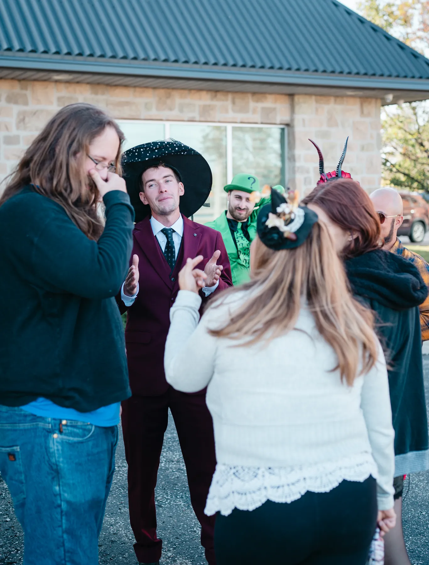 Costumed guests socializing at Jenna and Jake’s Halloween party.