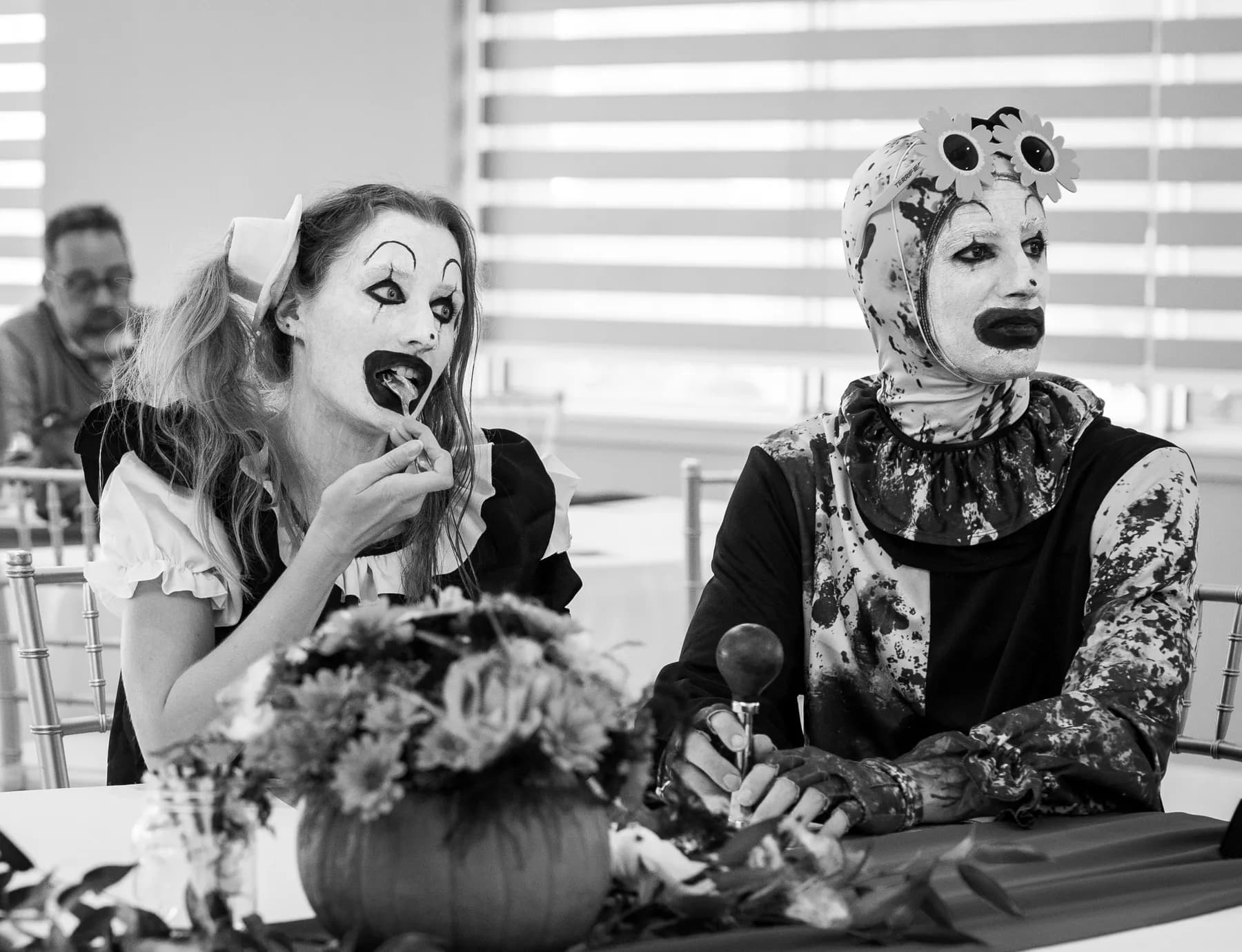 Costumed guests seated at a decorated table at Jenna and Jake’s Halloween party.