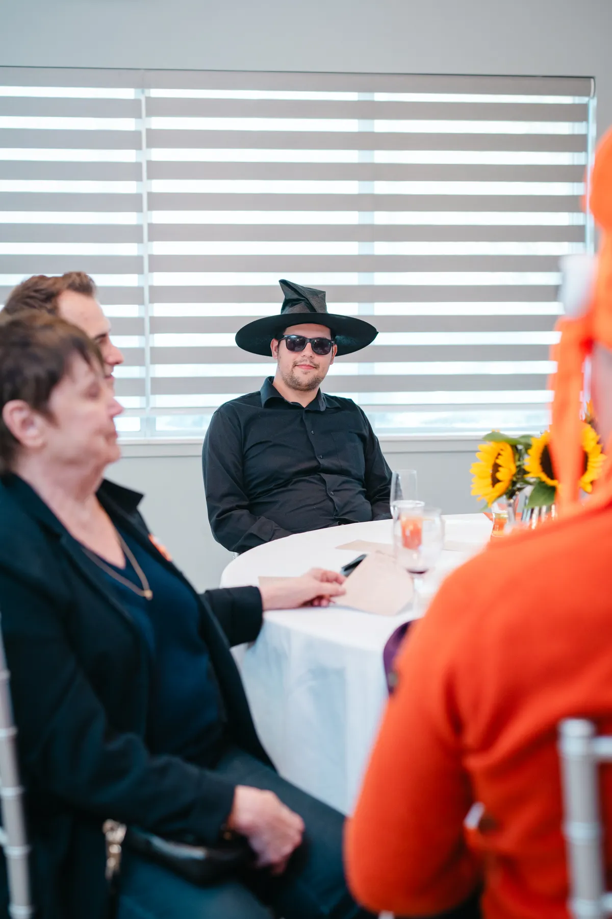 Guests chatting at party tables at Jenna and Jake’s Halloween party.