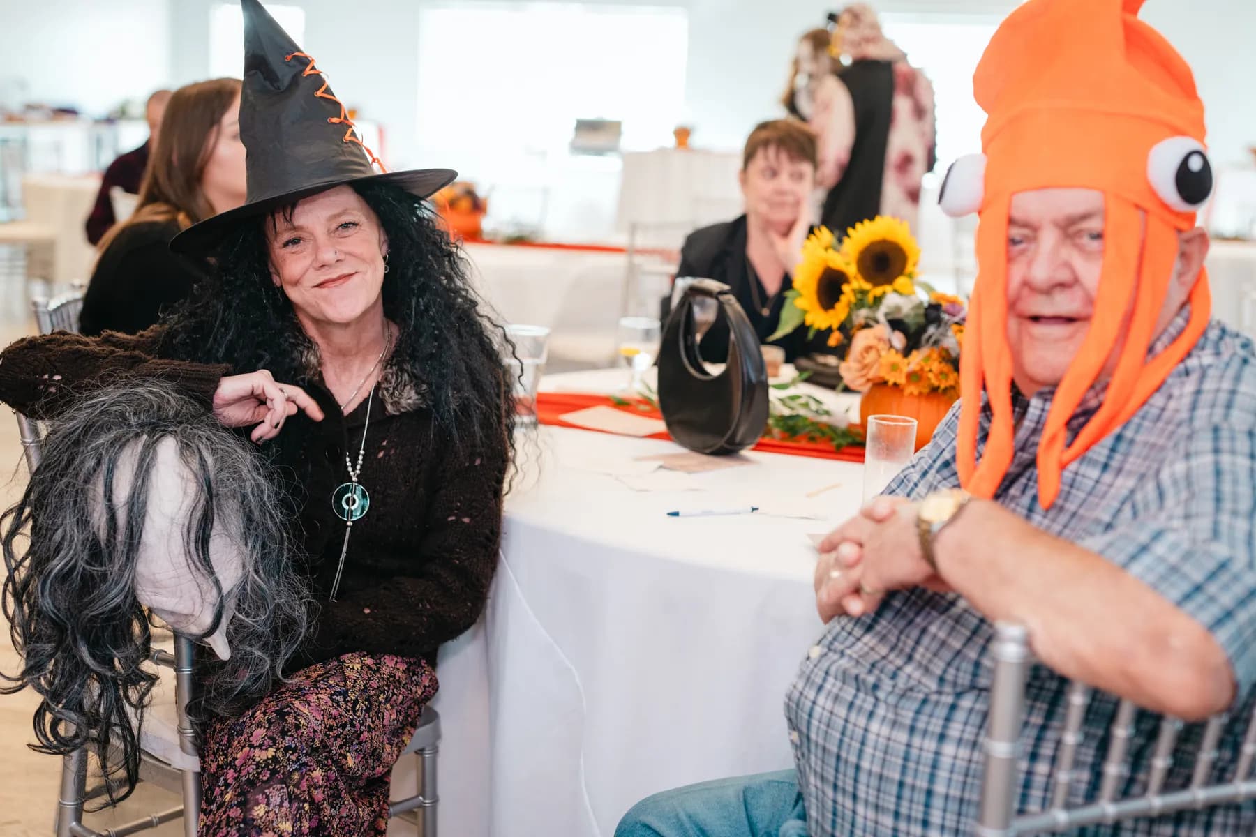 Costumed guests posing together indoors at Jenna and Jake’s Halloween party.