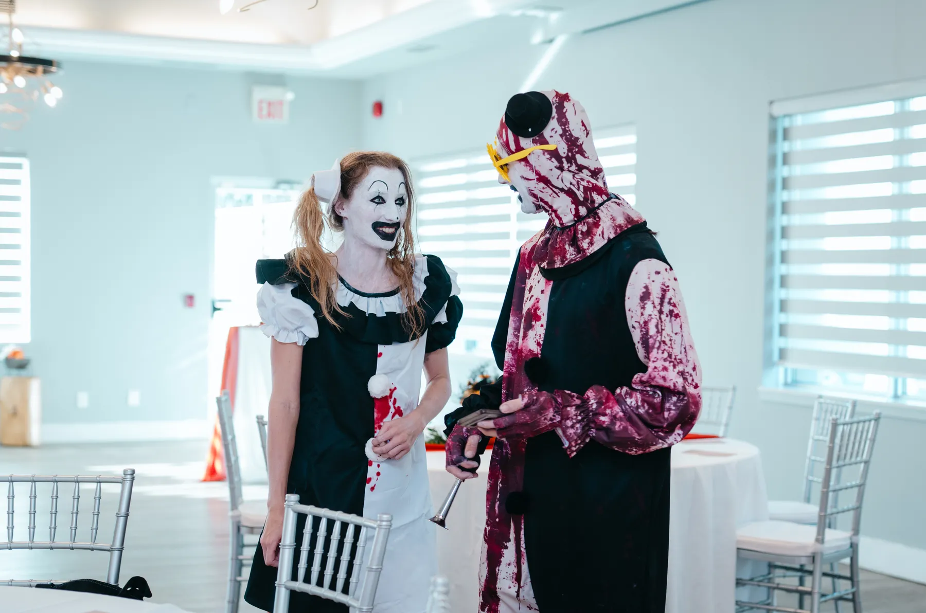 Costumed guests posing together indoors at Jenna and Jake’s Halloween party.