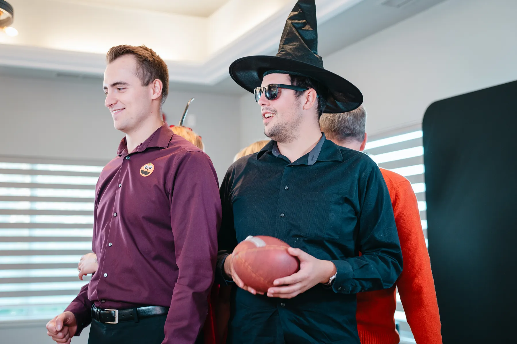 Costumed guests posing and mingling at Jenna and Jake’s Halloween party.