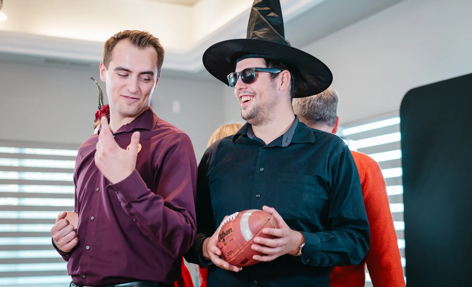 Costumed guests posing and mingling at Jenna and Jake’s Halloween party.