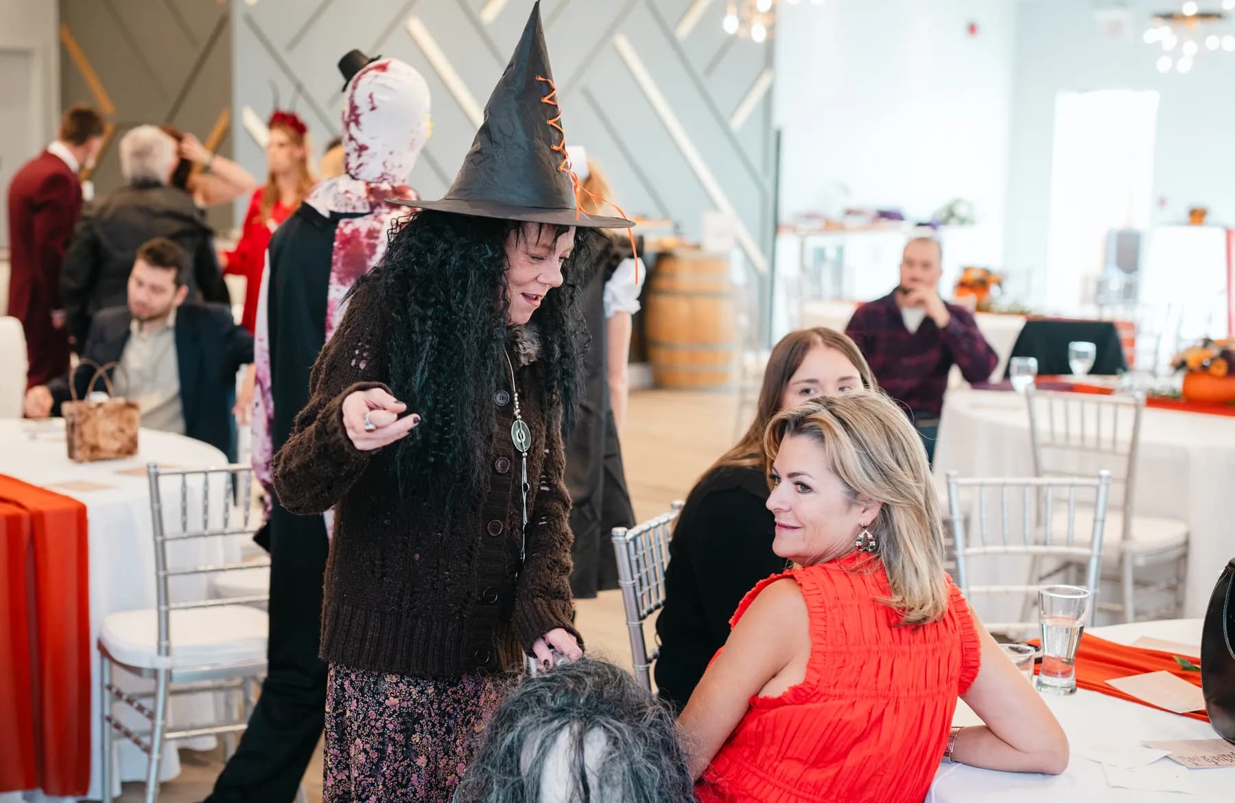 Costumed guests posing and mingling at Jenna and Jake’s Halloween party.