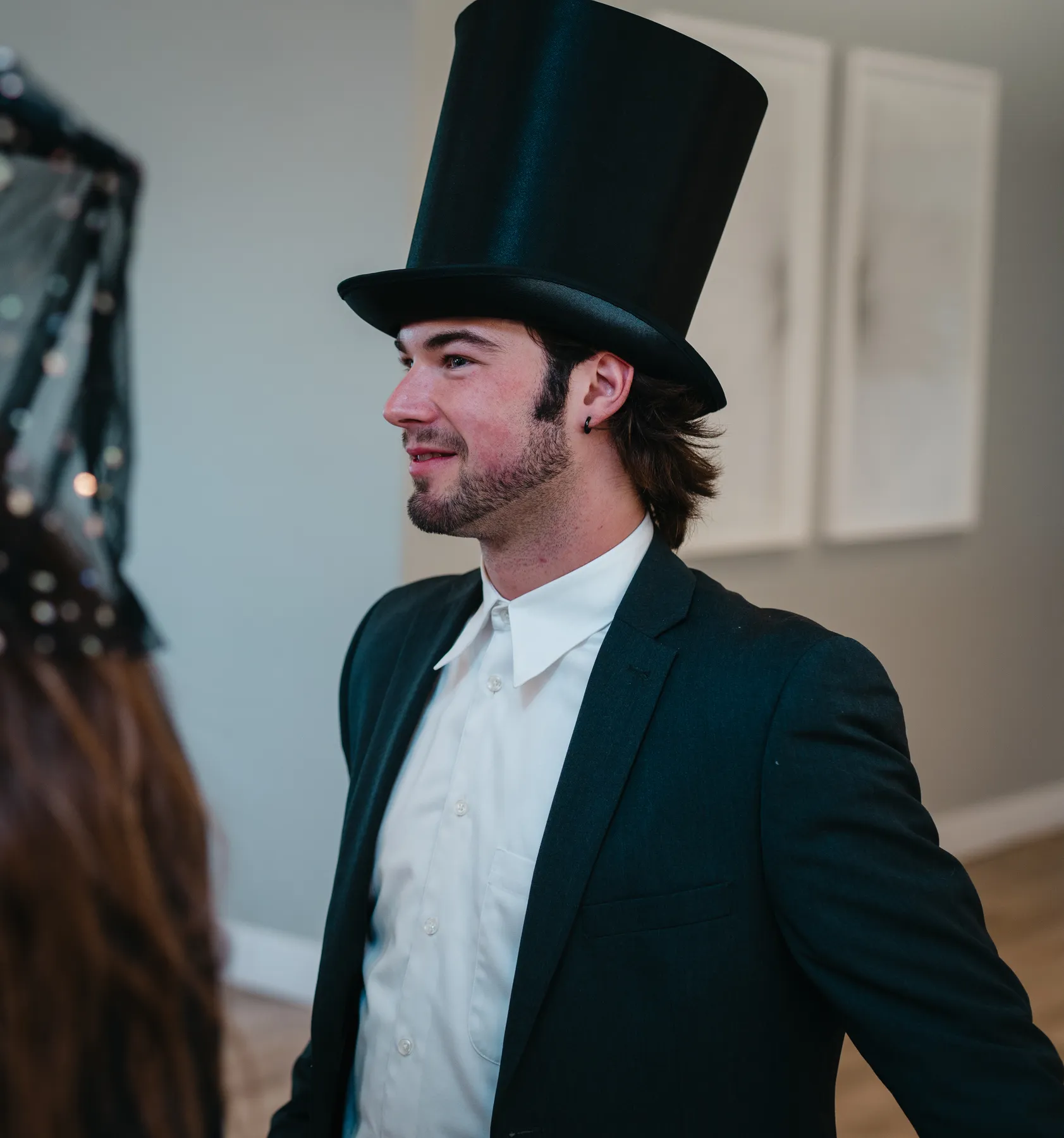 Costumed guests chatting and posing indoors at Jenna and Jake’s Halloween party.