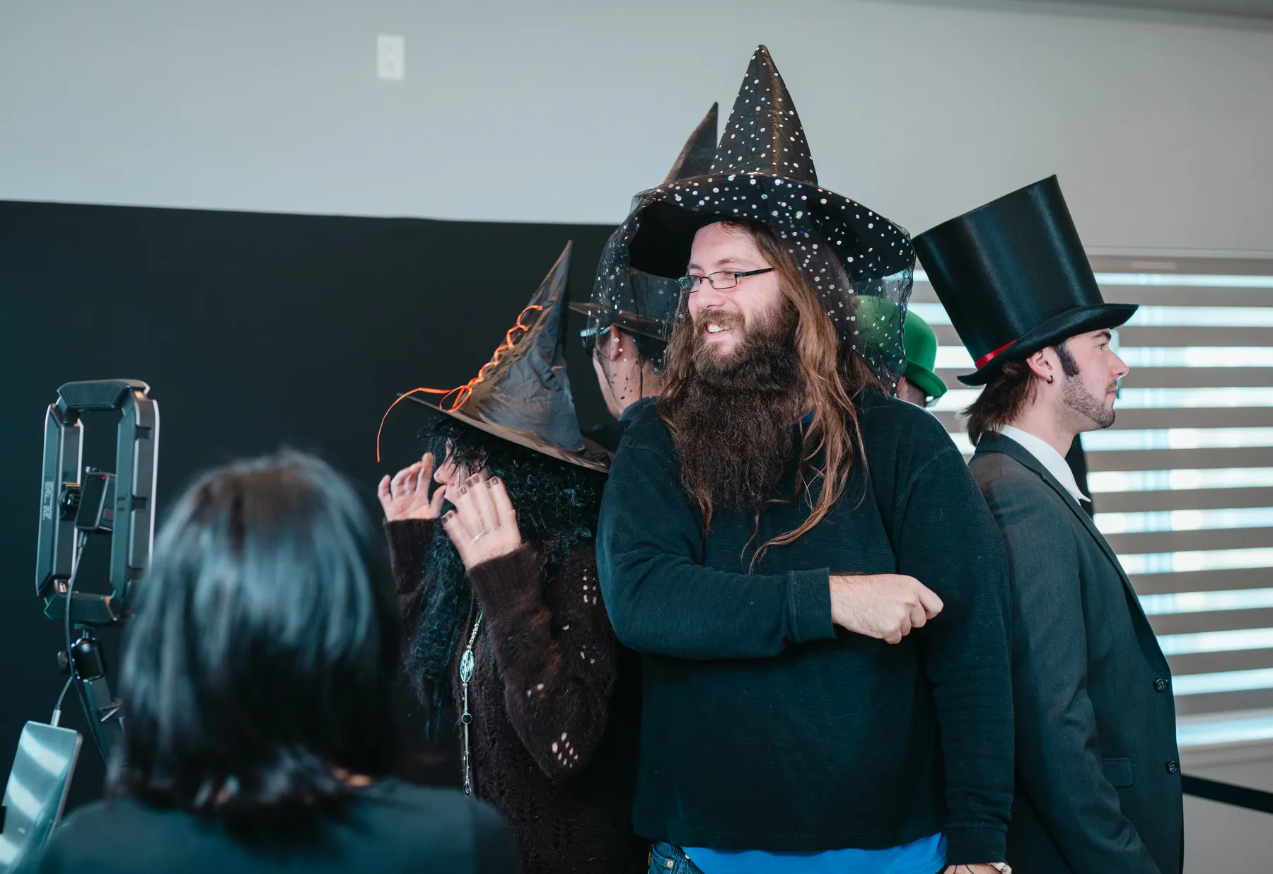 Costumed guests chatting and posing indoors at Jenna and Jake’s Halloween party.