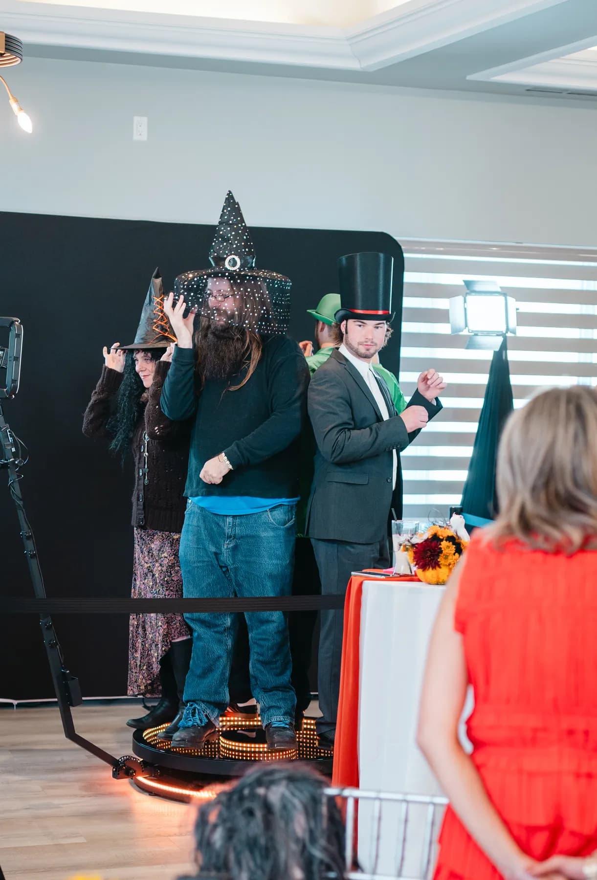 Costumed guests chatting and posing indoors at Jenna and Jake’s Halloween party.