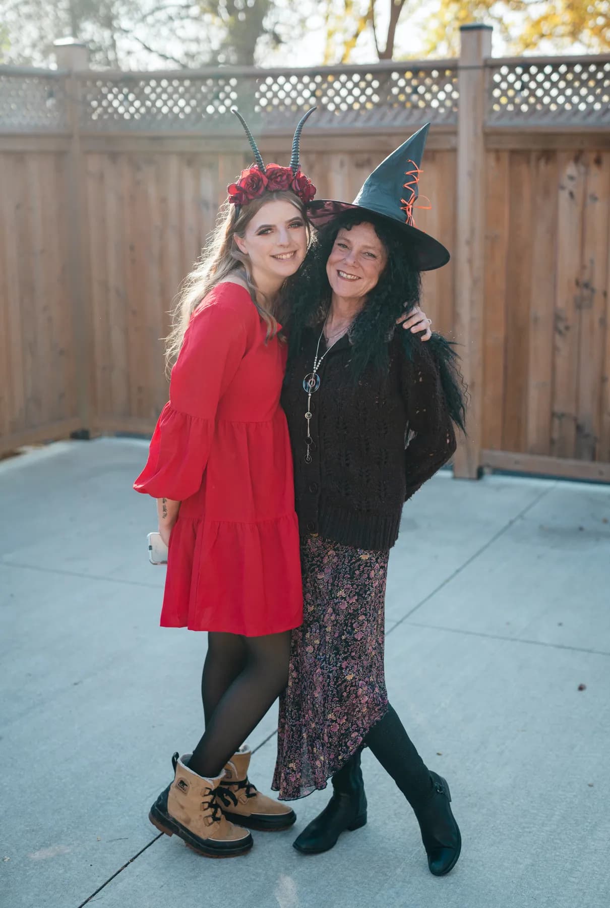 Guests walking and chatting in the outdoor courtyard at Jenna and Jake’s Halloween party.