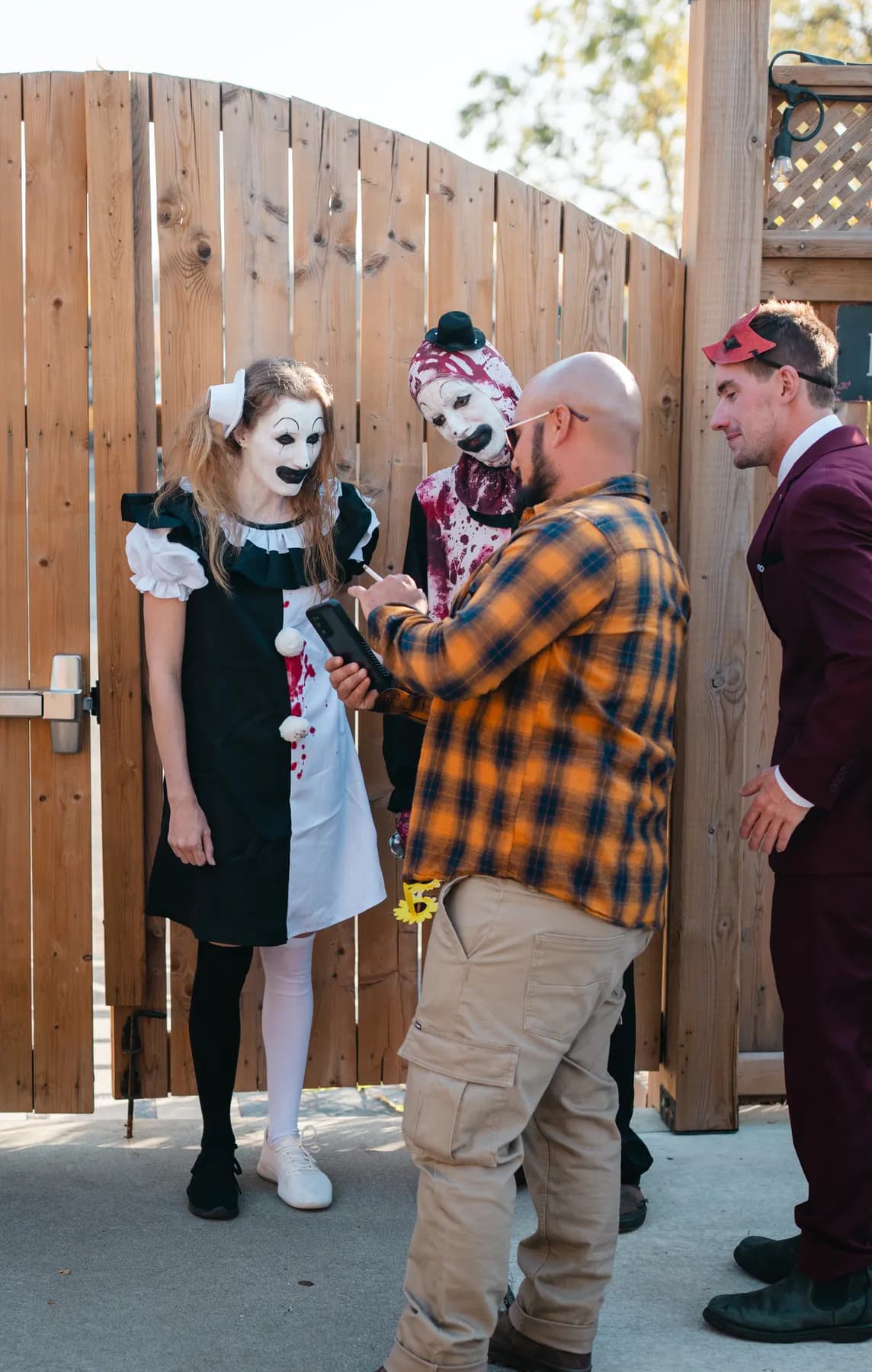 Guests walking and chatting in the outdoor courtyard at Jenna and Jake’s Halloween party.
