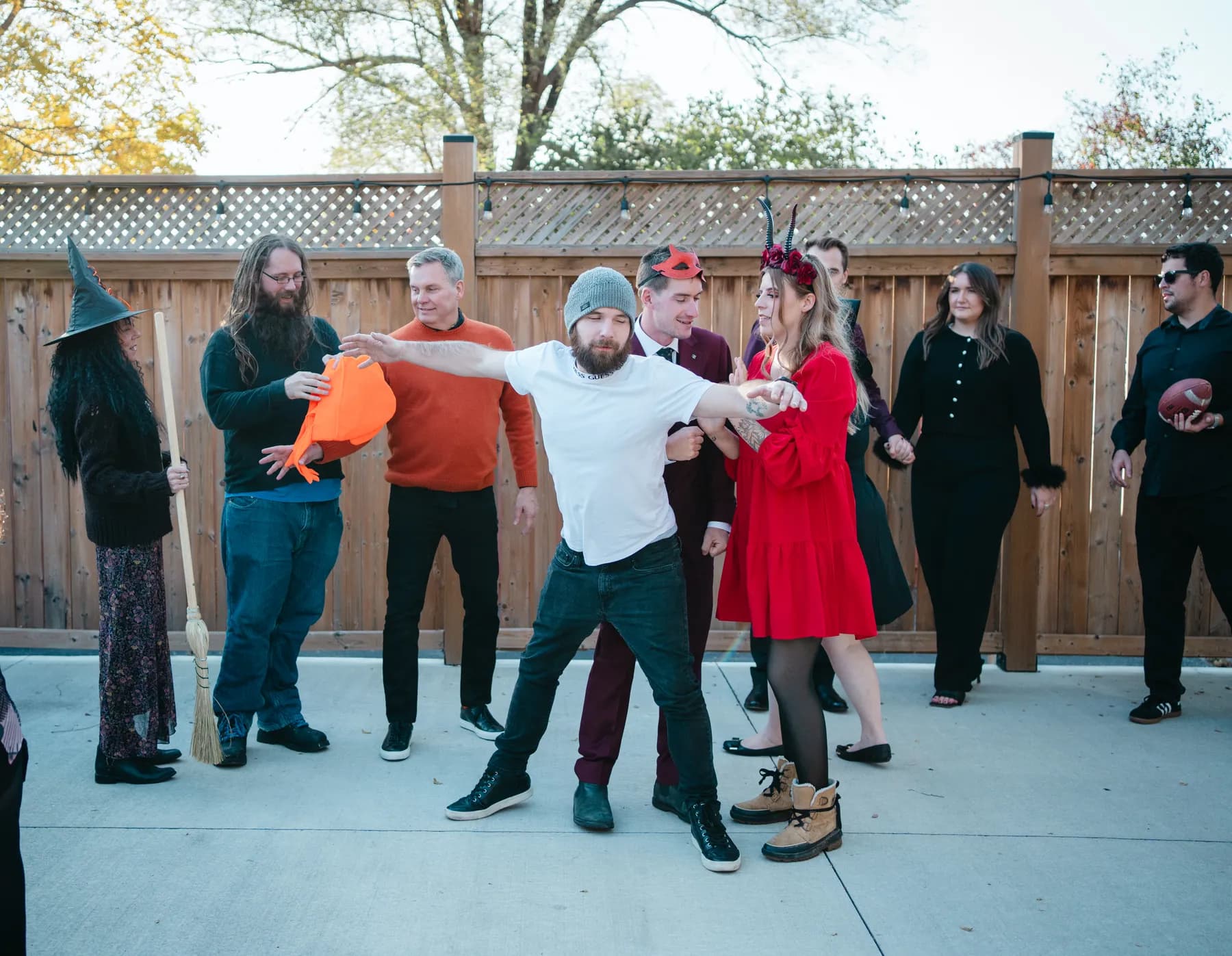 A large group of Halloween party guests posing outdoors at Jenna and Jake’s Halloween party.