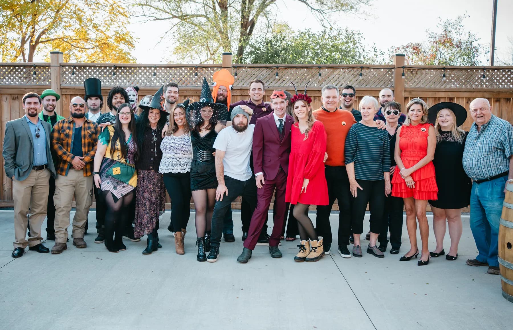 A large group of Halloween party guests posing outdoors at Jenna and Jake’s Halloween party.