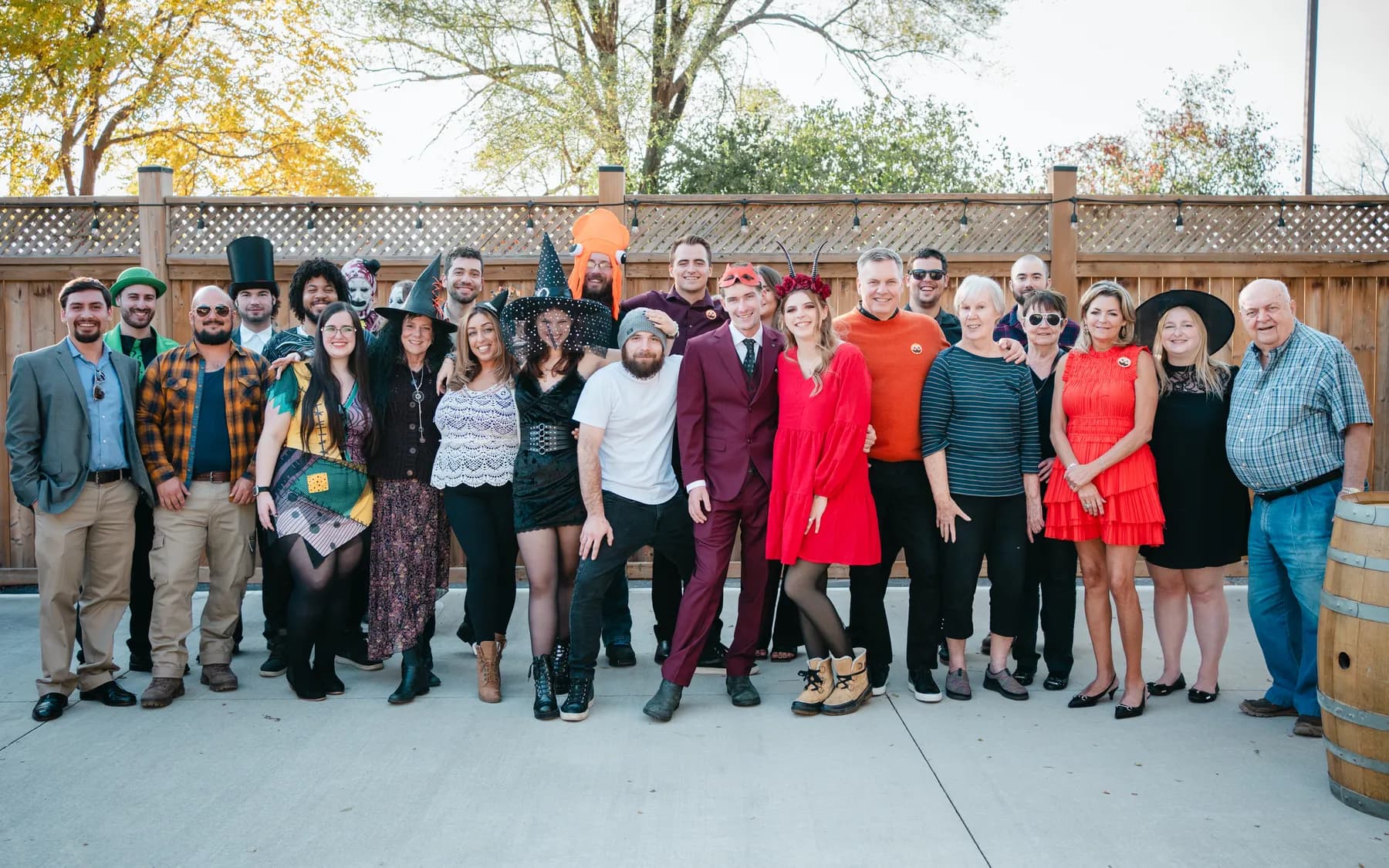 A large group of Halloween party guests posing outdoors at Jenna and Jake’s Halloween party.