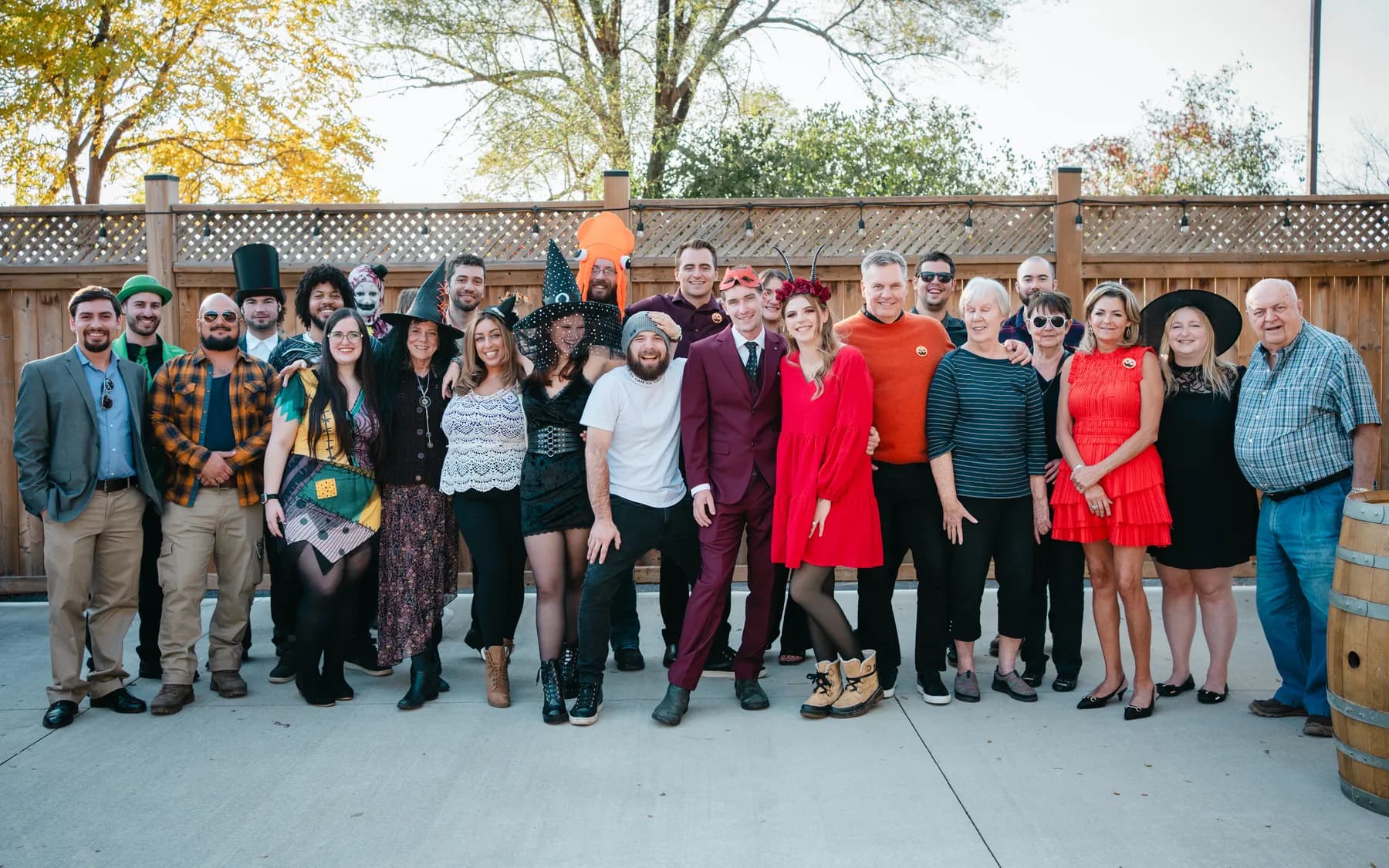 A large group of Halloween party guests posing outdoors at Jenna and Jake’s Halloween party.