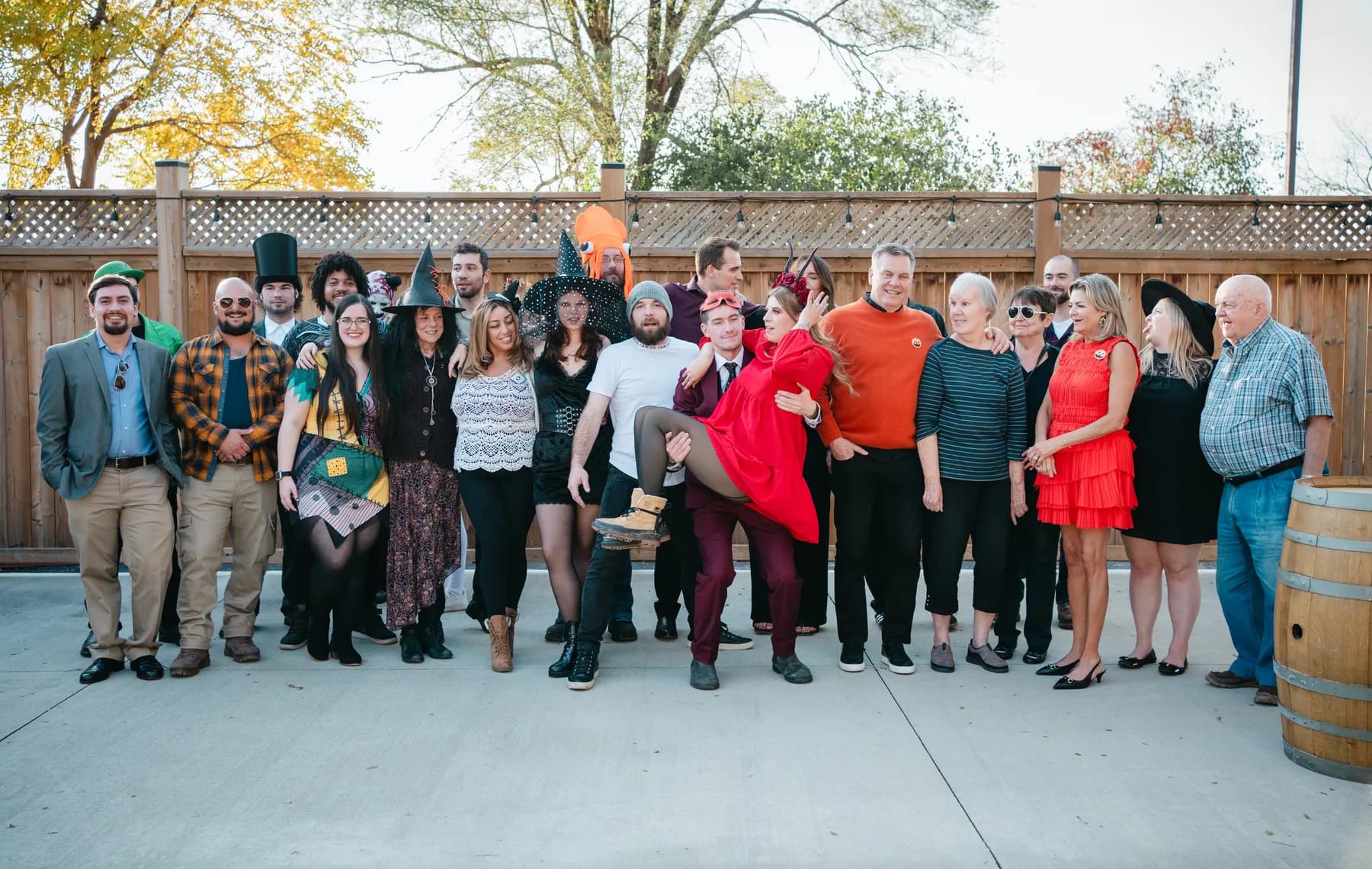 A large group of Halloween party guests posing outdoors at Jenna and Jake’s Halloween party.