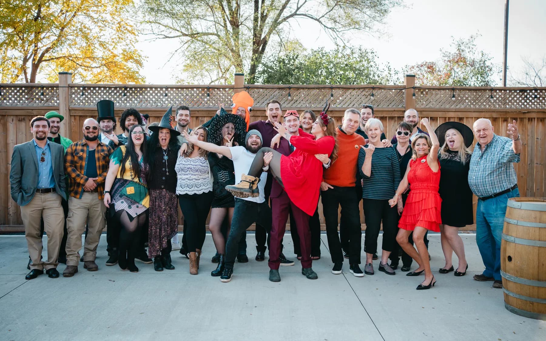 A large group of Halloween party guests posing outdoors at Jenna and Jake’s Halloween party.