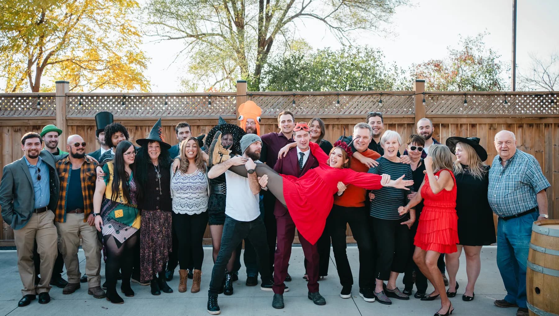A large group of Halloween party guests posing outdoors at Jenna and Jake’s Halloween party.