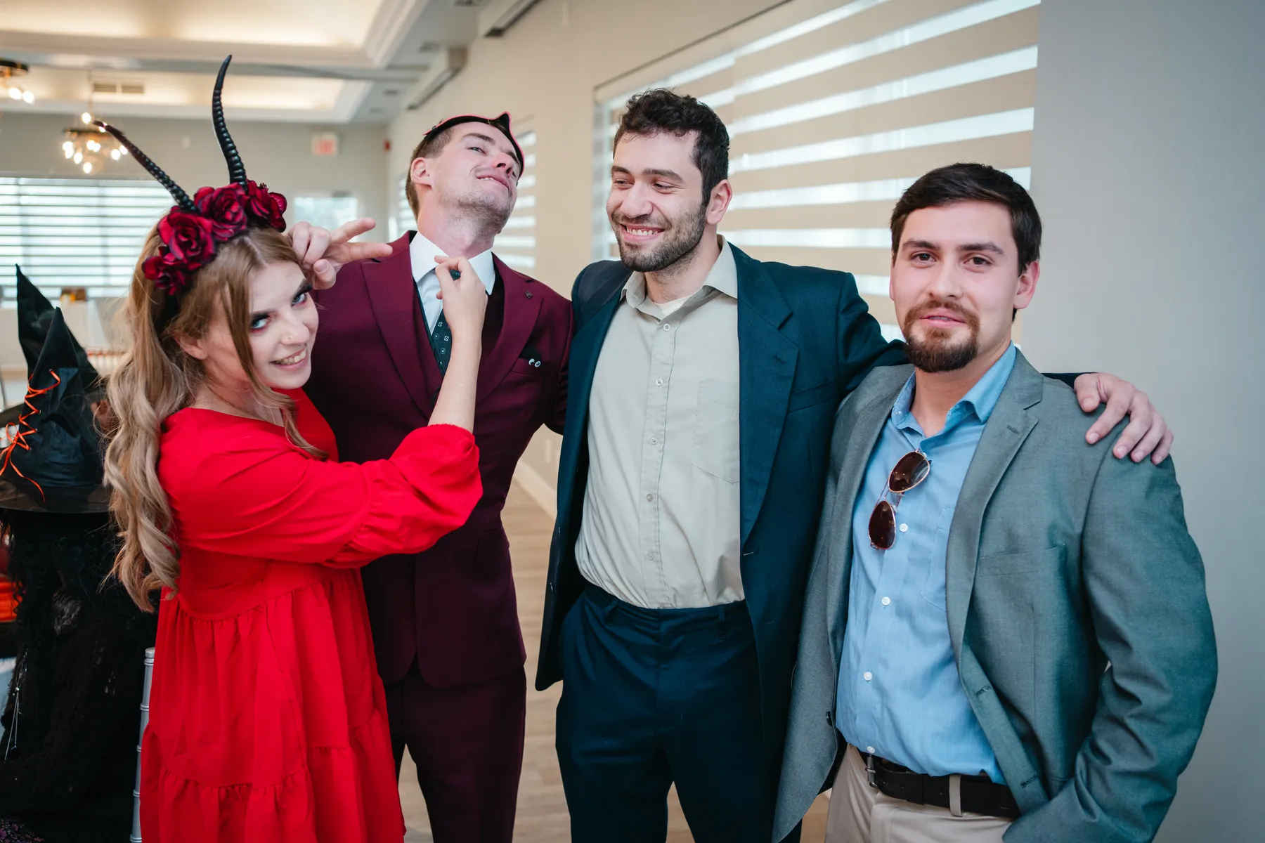 A small group of guests posing indoors at Jenna and Jake’s Halloween party.