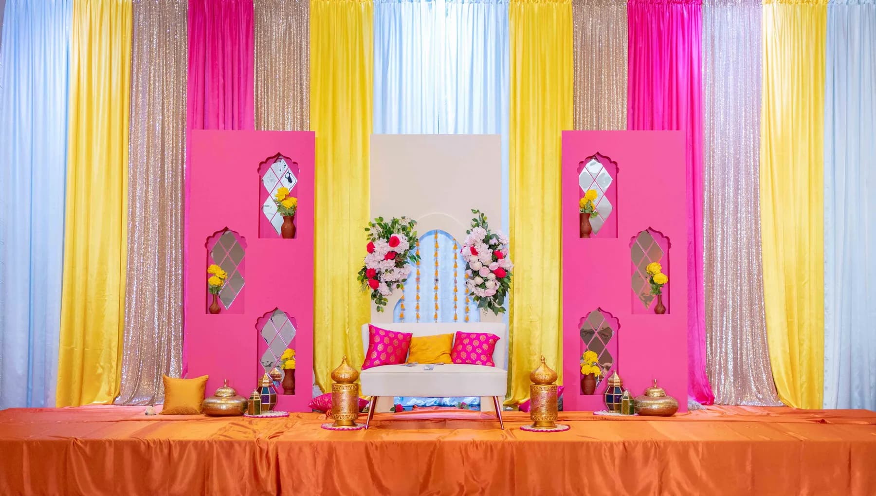 The decorated celebration stage at Jessie and Erin’s Haldi celebration.