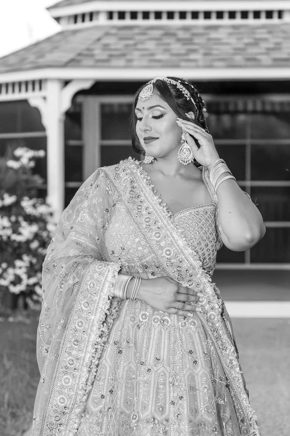 A black and white portrait of a woman at Jessie and Erin’s Haldi celebration.