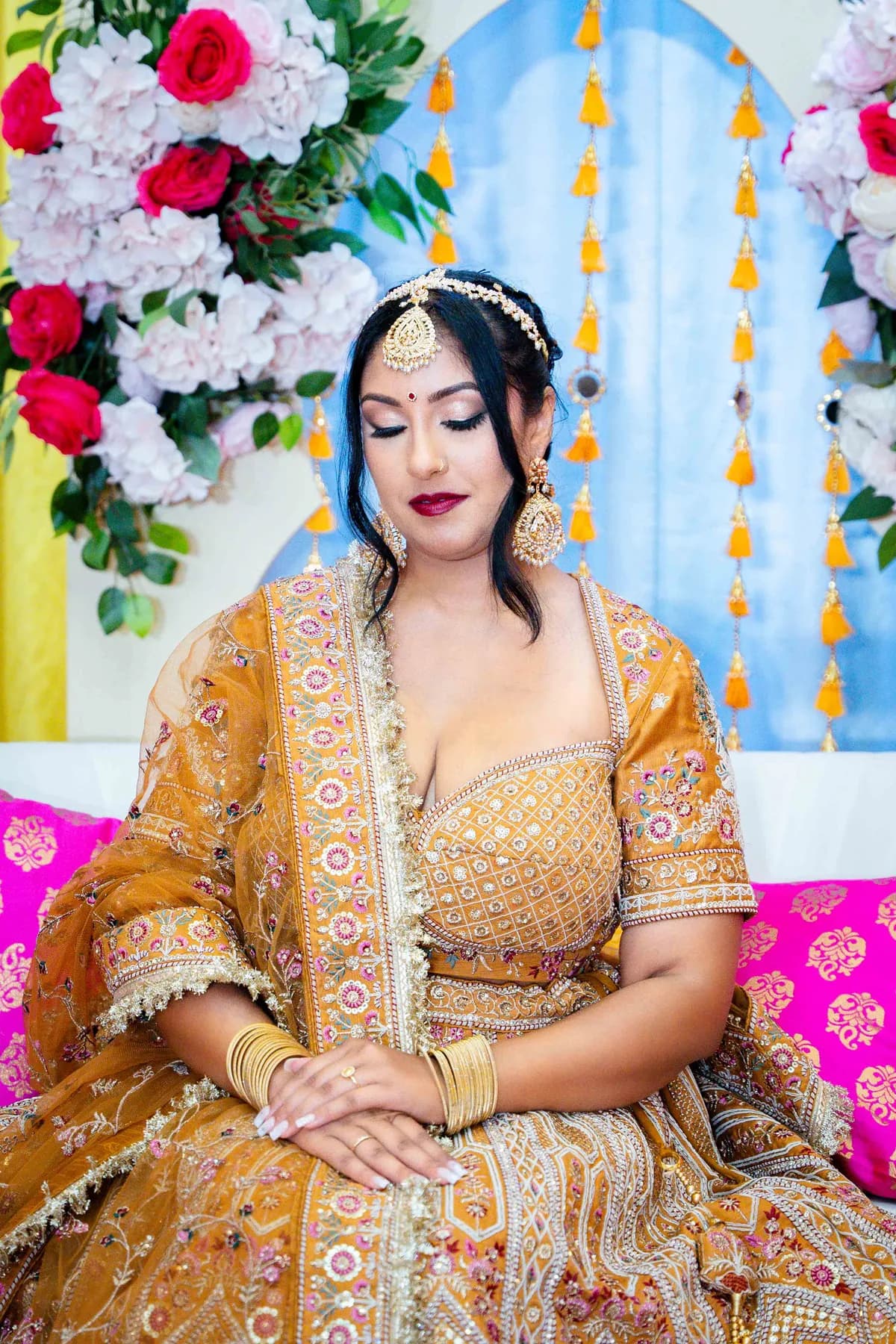 Portraits and outfit details of a woman in gold at Jessie and Erin’s Haldi celebration.