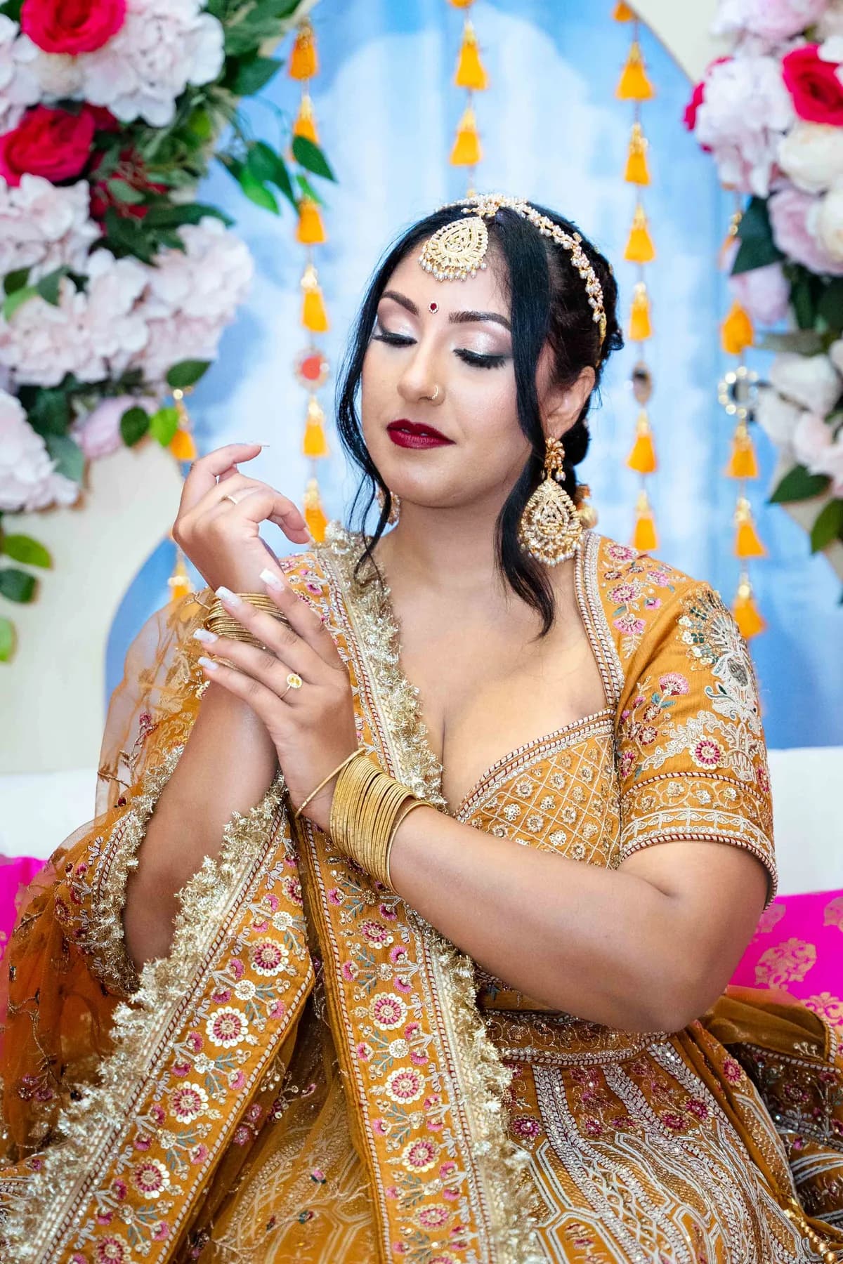 Portraits and outfit details of a woman in gold at Jessie and Erin’s Haldi celebration.