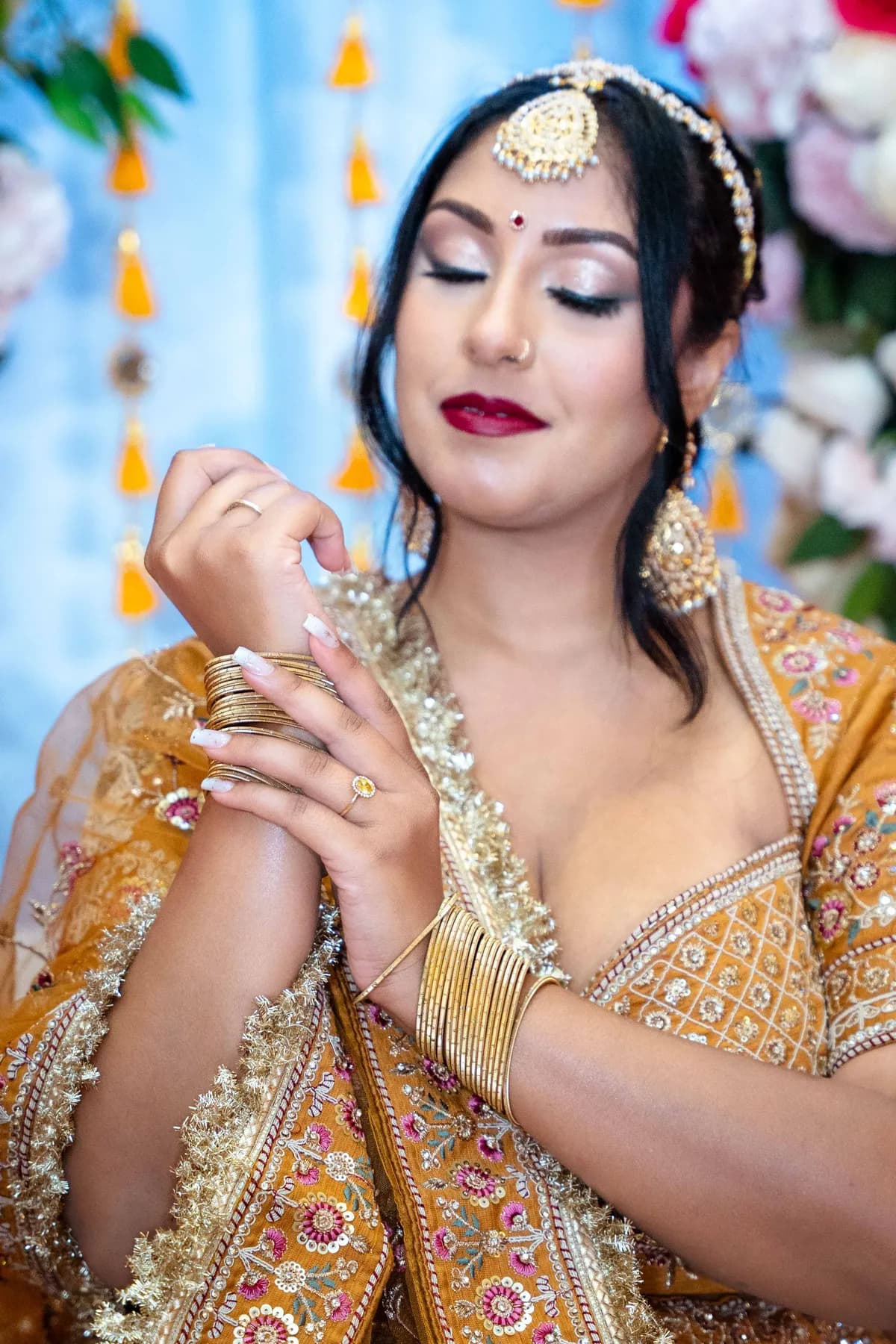 Portraits and outfit details of a woman in gold at Jessie and Erin’s Haldi celebration.