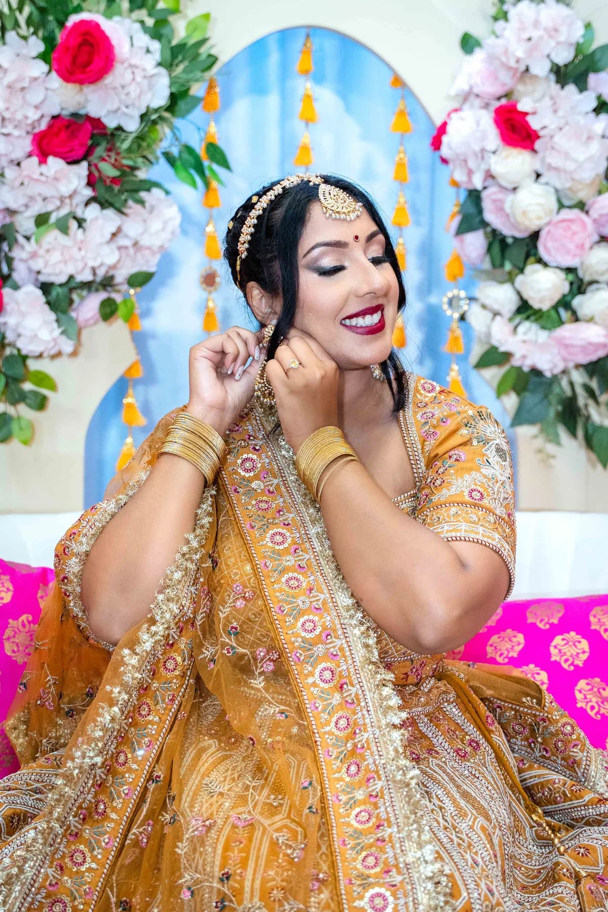 Portraits and outfit details of a woman in gold at Jessie and Erin’s Haldi celebration.