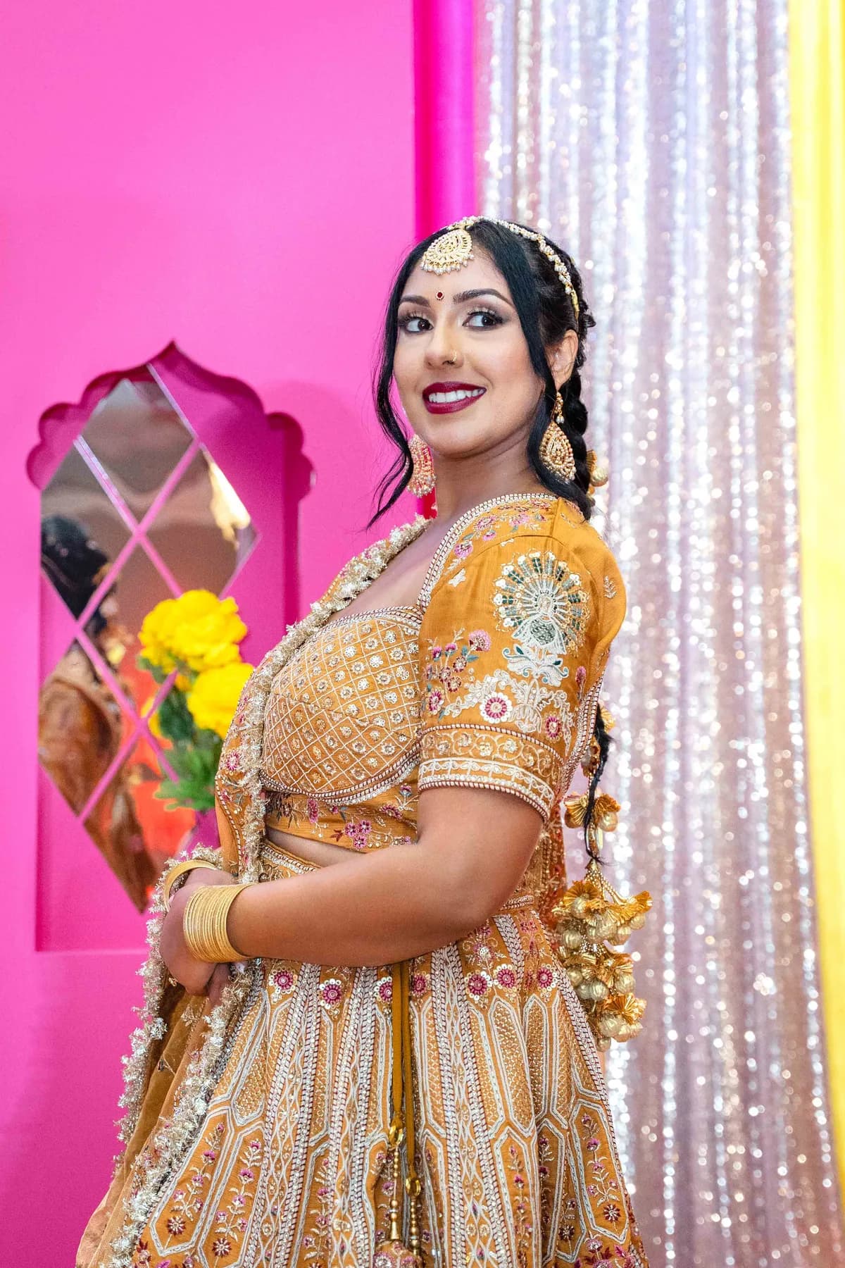 Portraits and outfit details of a woman in gold at Jessie and Erin’s Haldi celebration.