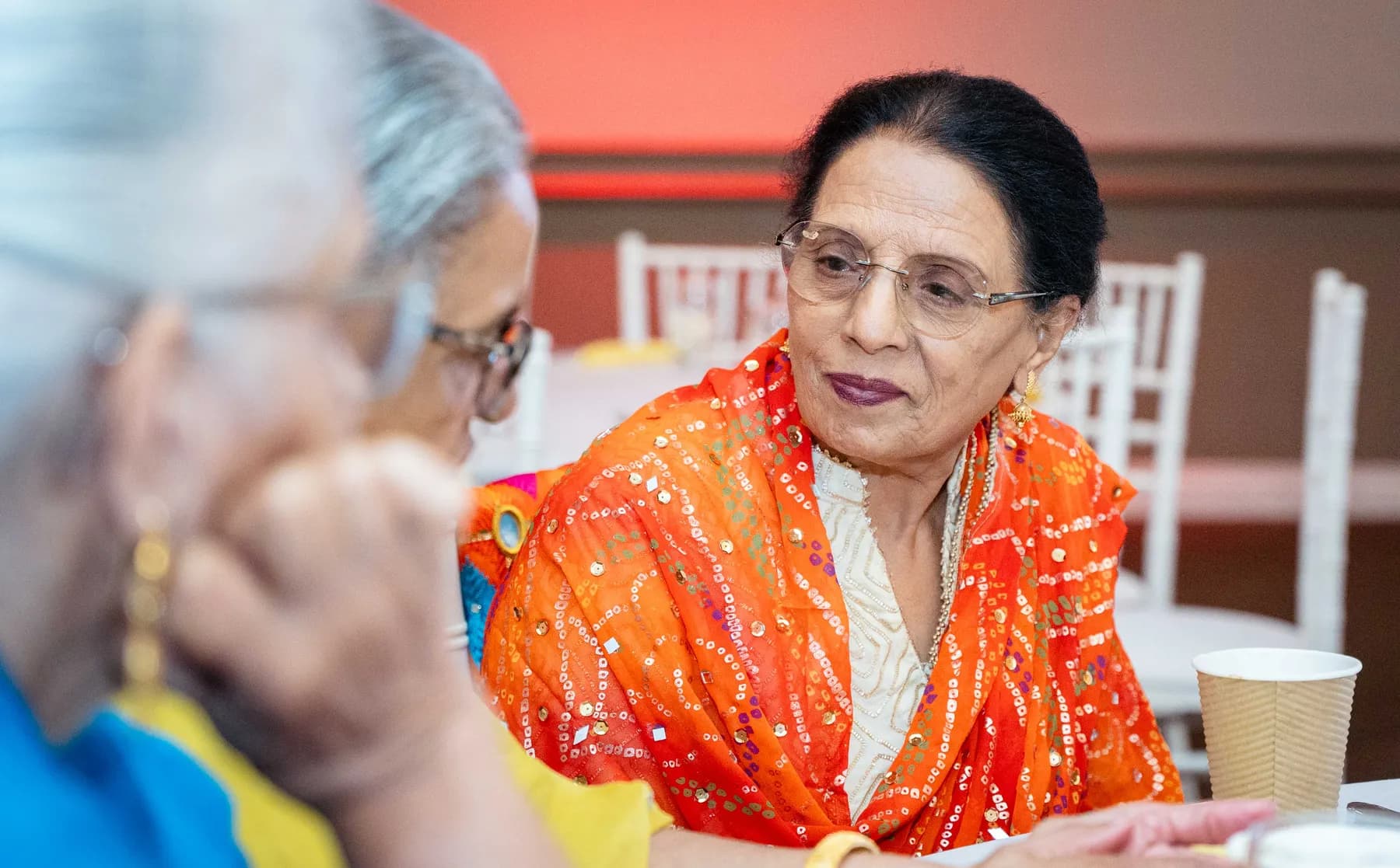Guests talking together at Jessie and Erin’s Haldi celebration.