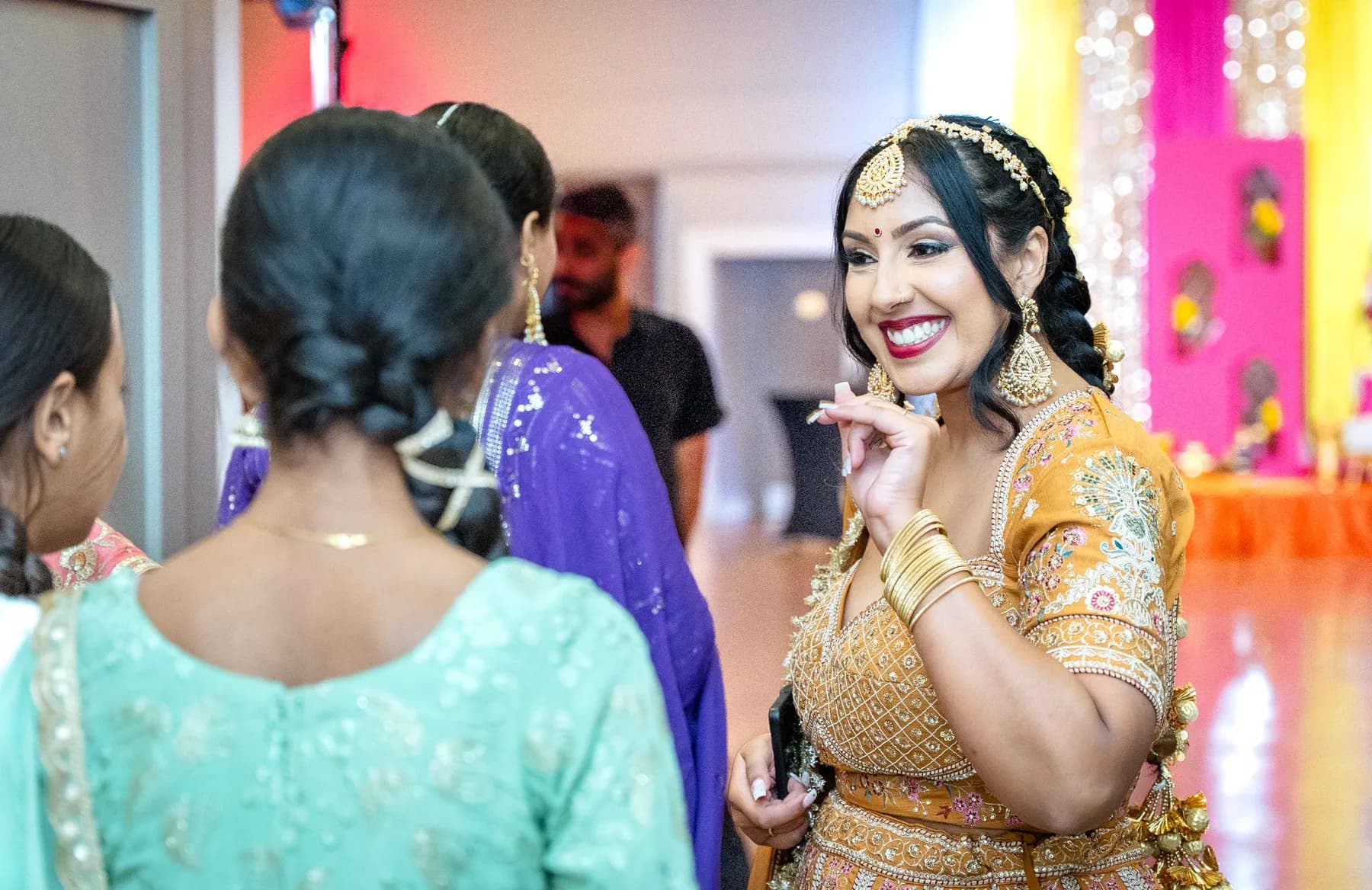Guests talking together at Jessie and Erin’s Haldi celebration.