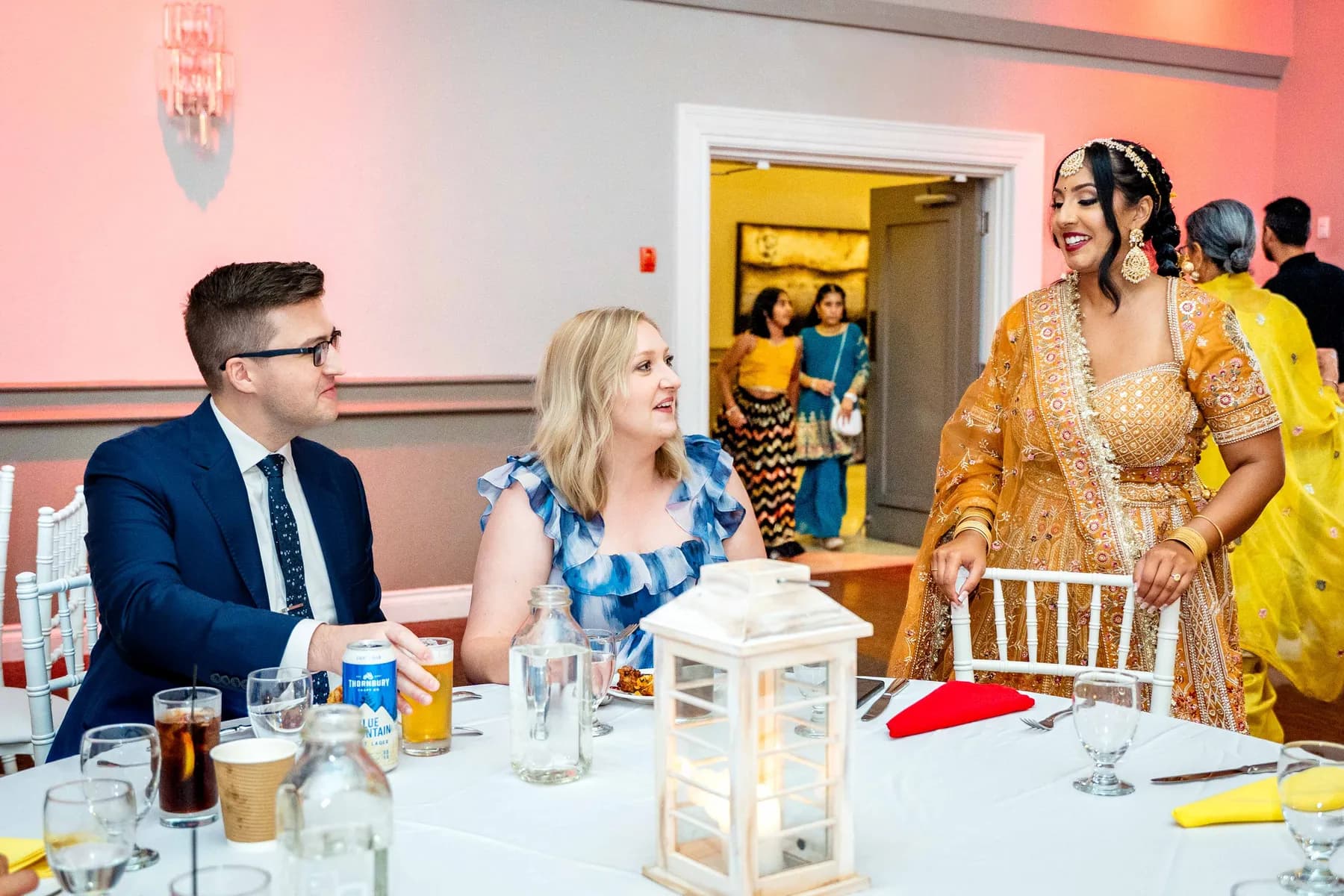 Guests talking together at Jessie and Erin’s Haldi celebration.