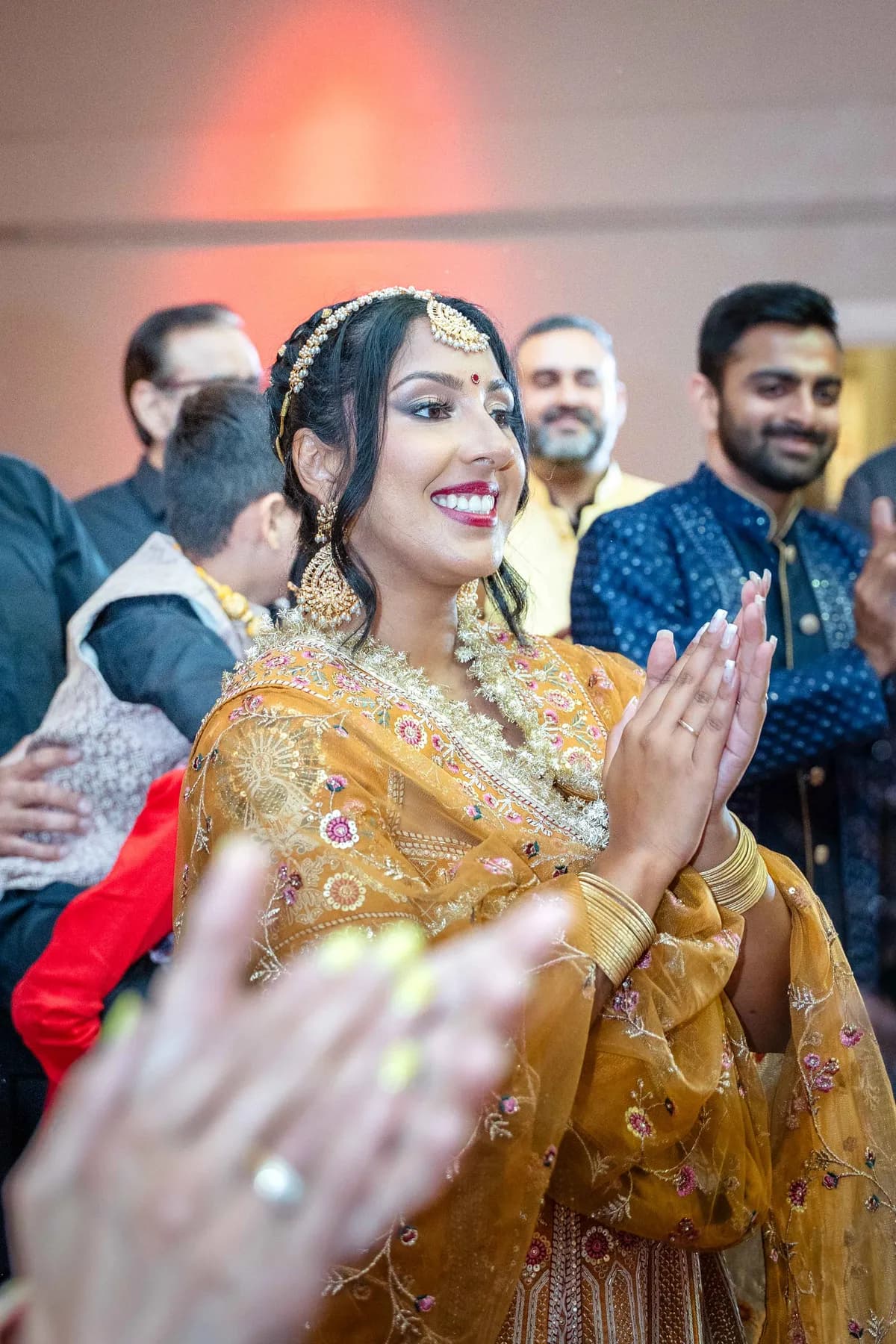 Guests dancing with decorated vessels at Jessie and Erin’s Haldi celebration.