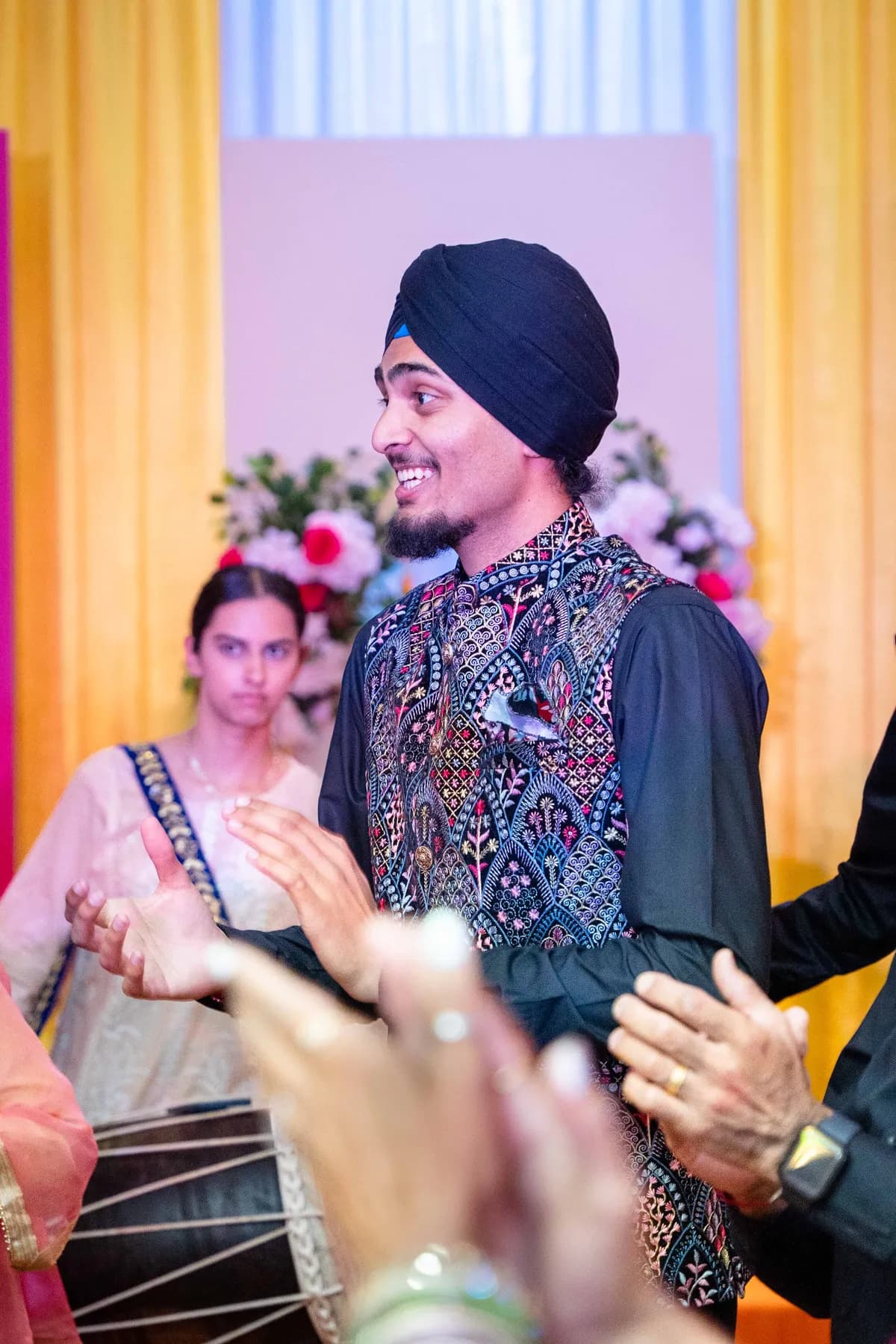 Guests dancing with decorated vessels at Jessie and Erin’s Haldi celebration.