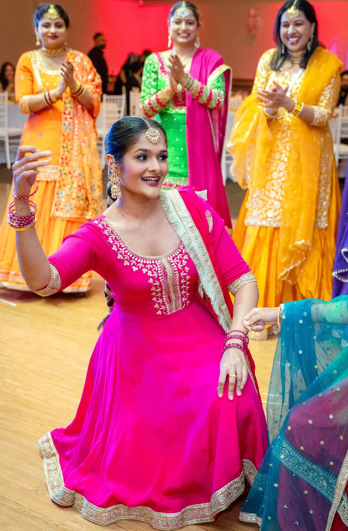 A woman dancing with the guests at Jessie and Erin’s Haldi celebration.