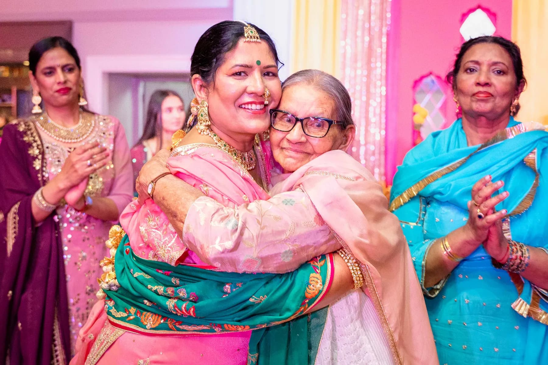 Guests sharing an embrace at Jessie and Erin’s Haldi celebration.