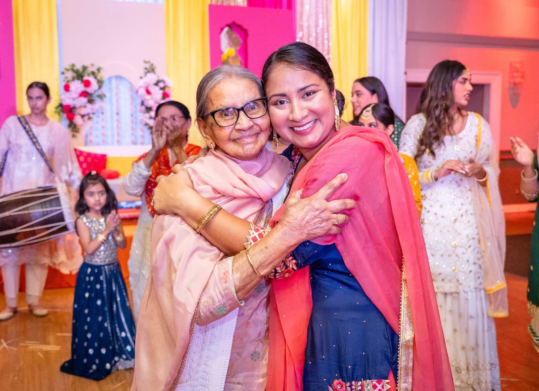Guests sharing an embrace at Jessie and Erin’s Haldi celebration.