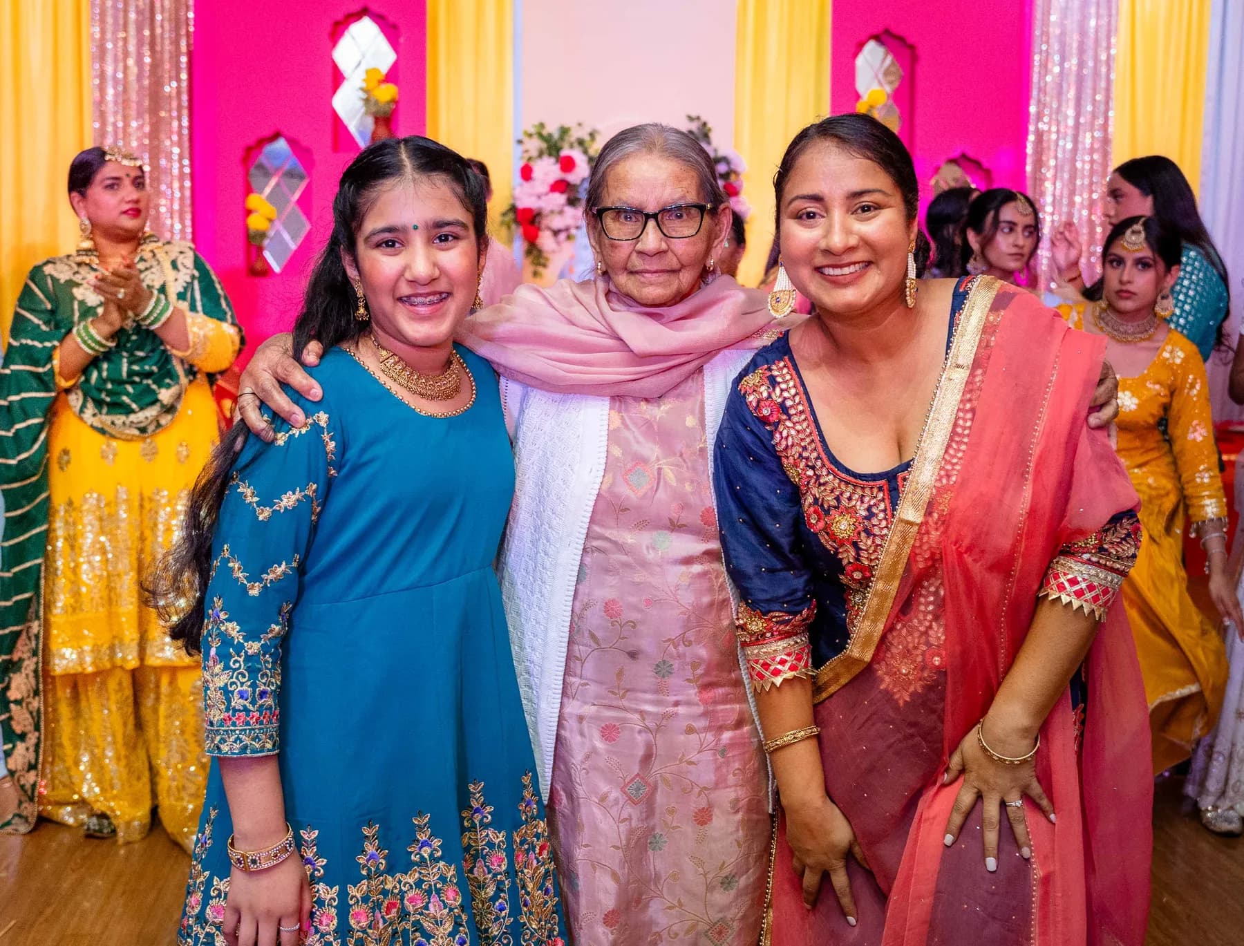 Guests posing together at Jessie and Erin’s Haldi celebration.