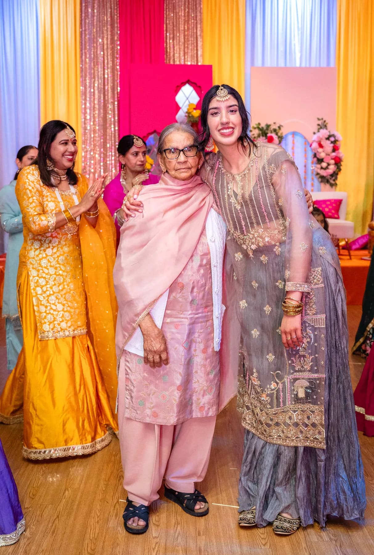 Guests posing together at Jessie and Erin’s Haldi celebration.