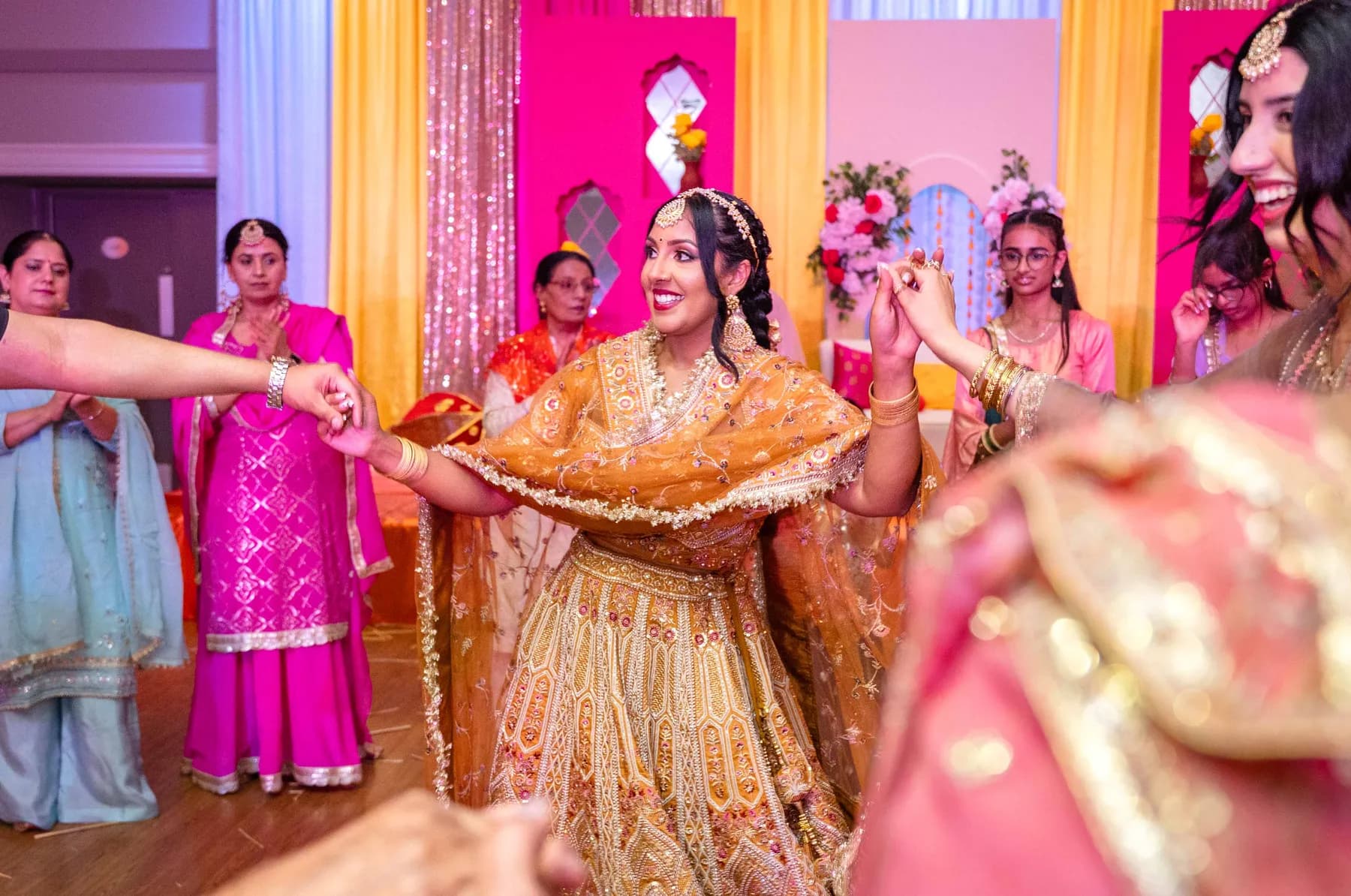 A woman dancing with the guests at Jessie and Erin’s Haldi celebration.
