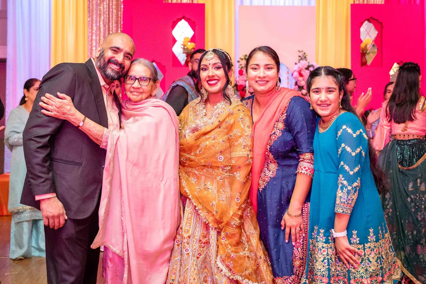 Guests posing together at Jessie and Erin’s Haldi celebration.