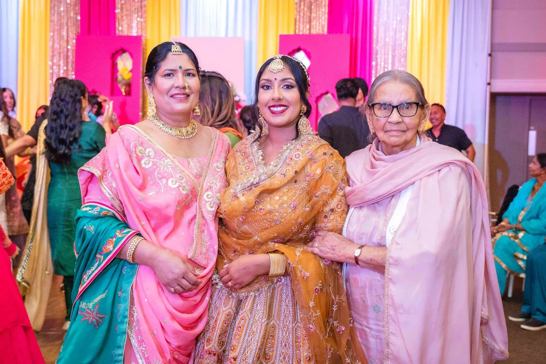 Guests posing together at Jessie and Erin’s Haldi celebration.