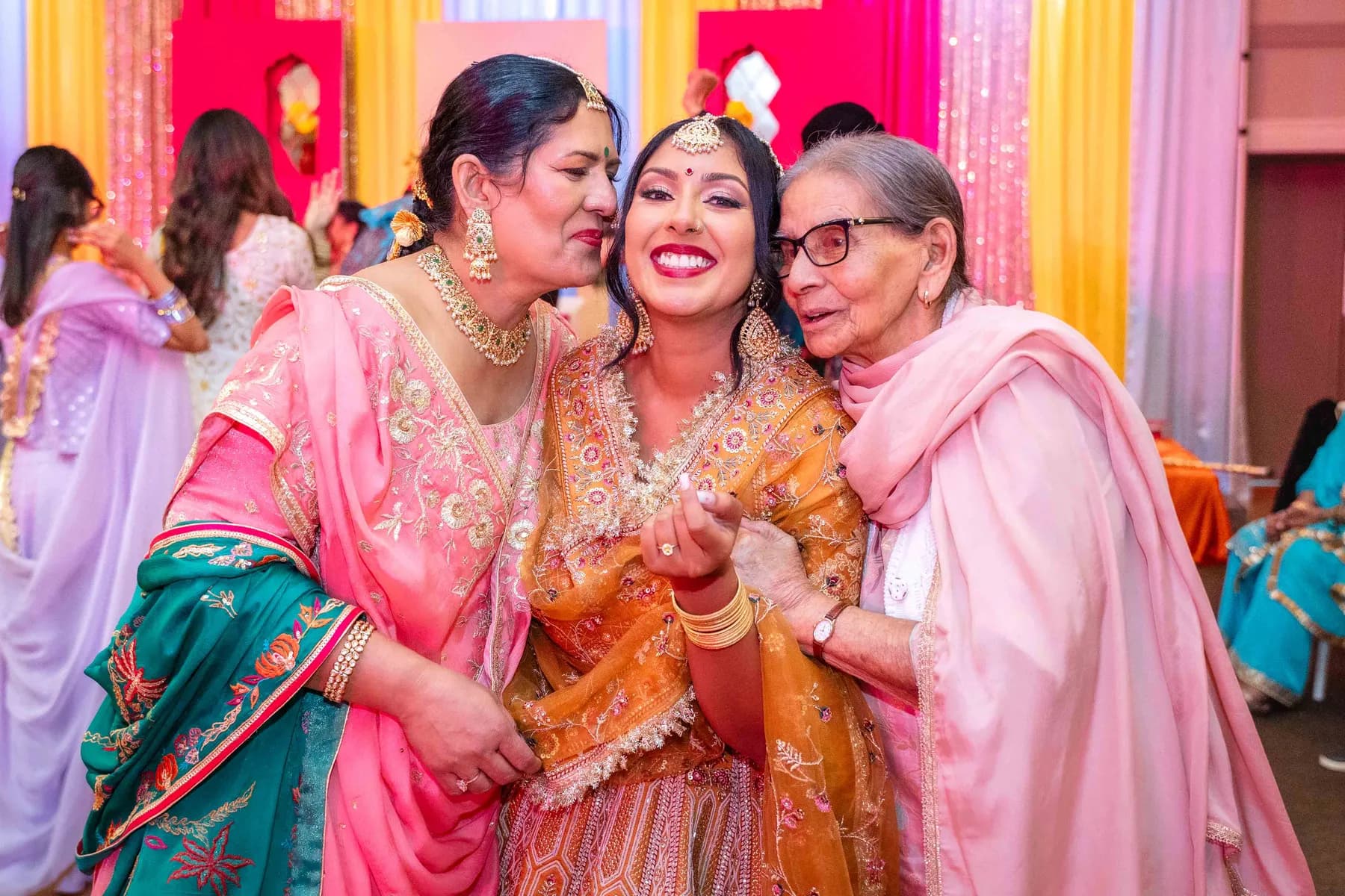 Guests posing together at Jessie and Erin’s Haldi celebration.