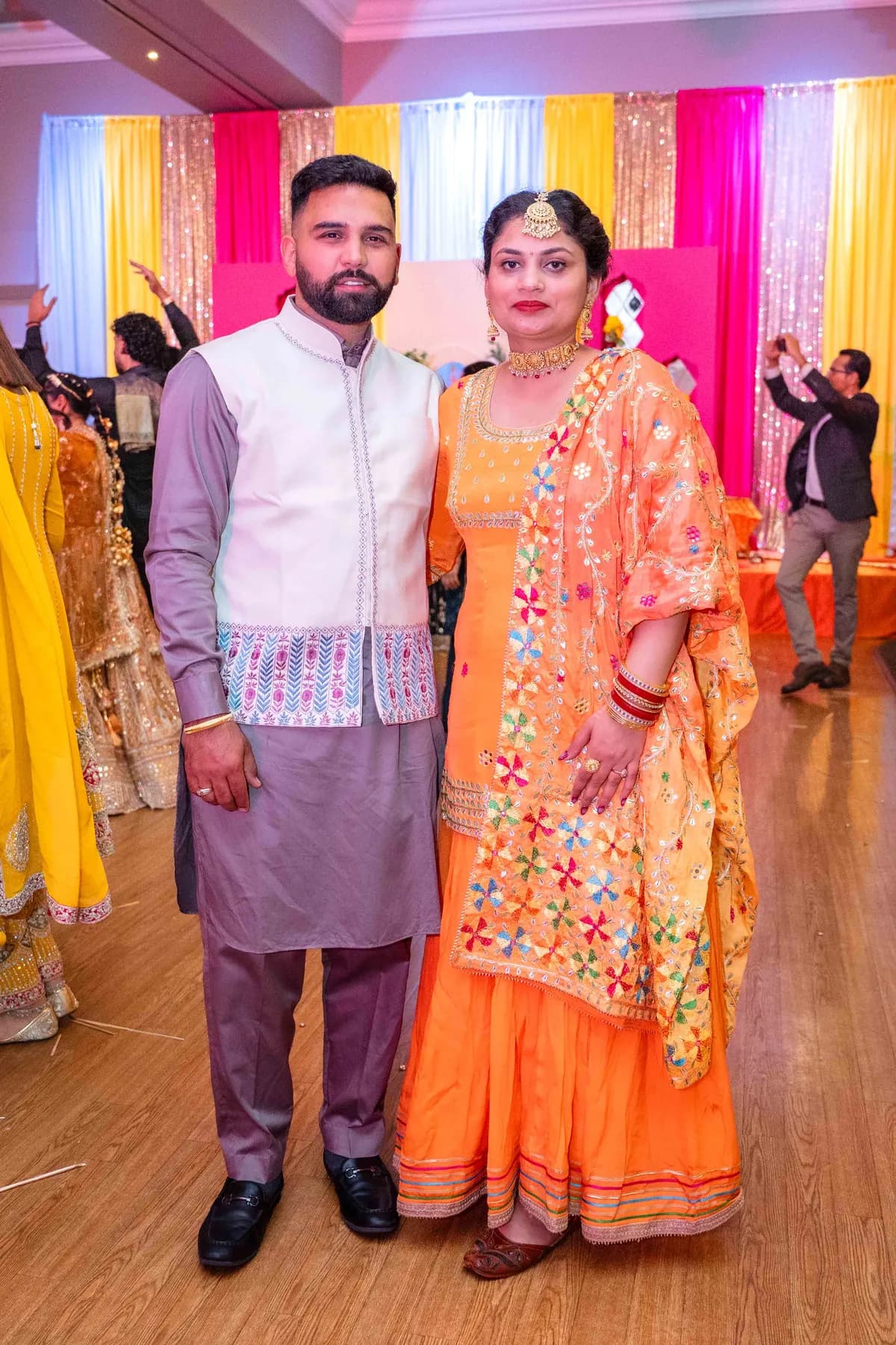 Guests posing together at Jessie and Erin’s Haldi celebration.
