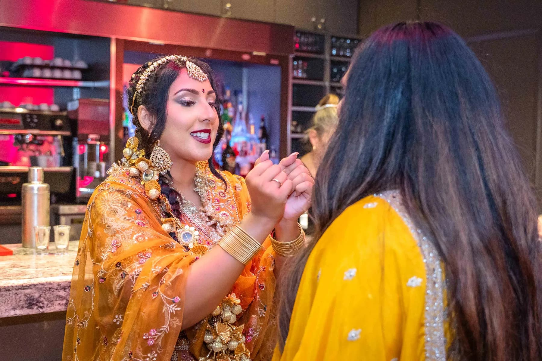 Guests gathered by the bar at Jessie and Erin’s Haldi celebration.