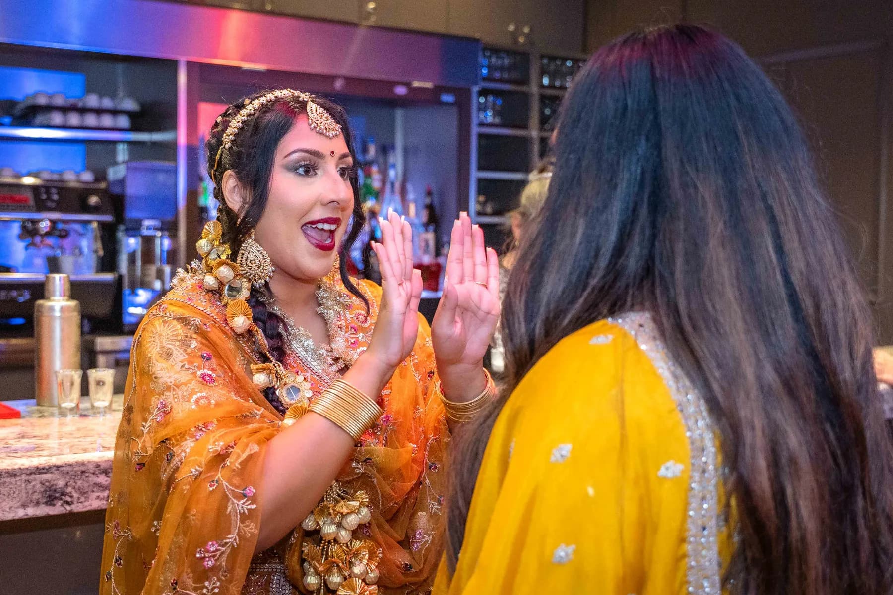 Guests gathered by the bar at Jessie and Erin’s Haldi celebration.