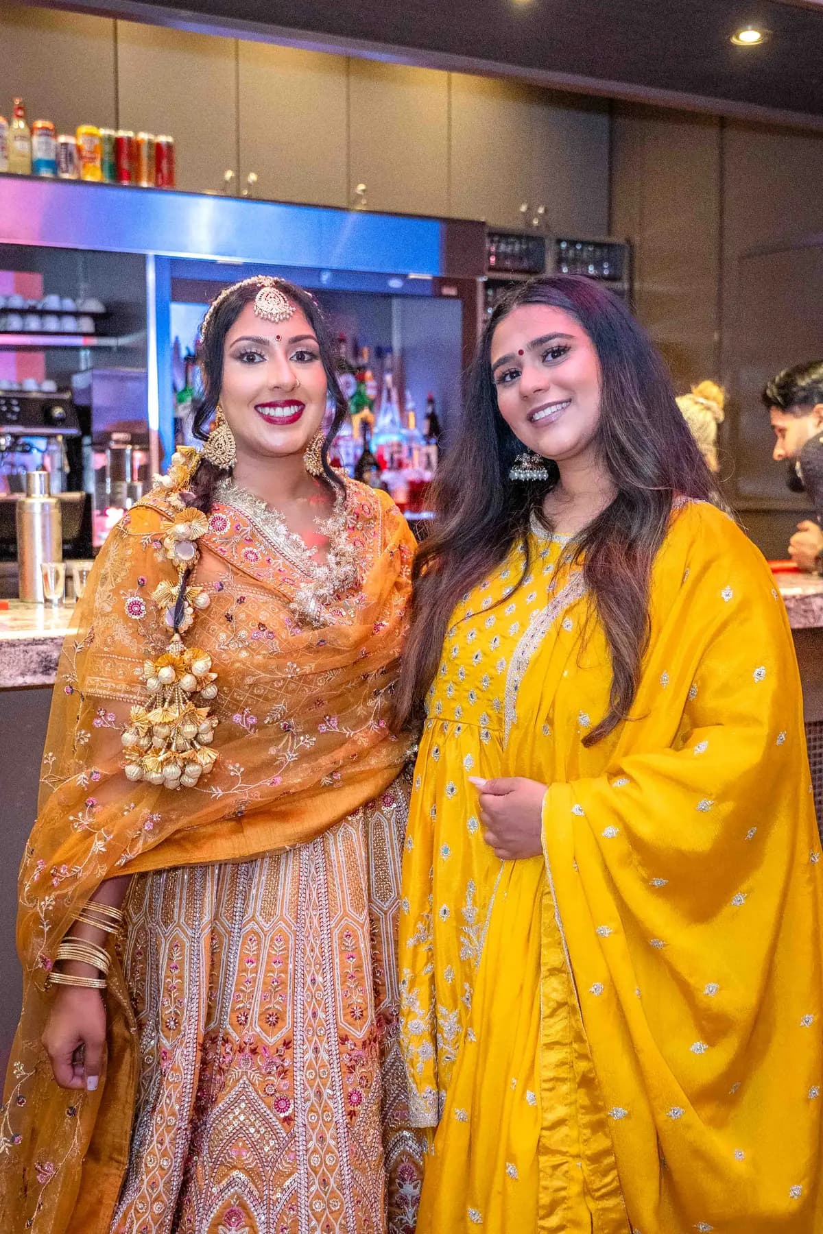 Guests gathered by the bar at Jessie and Erin’s Haldi celebration.