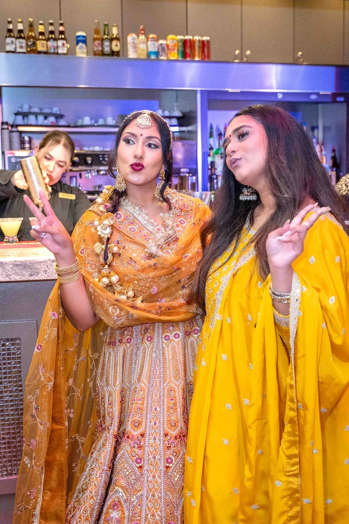 Guests gathered by the bar at Jessie and Erin’s Haldi celebration.