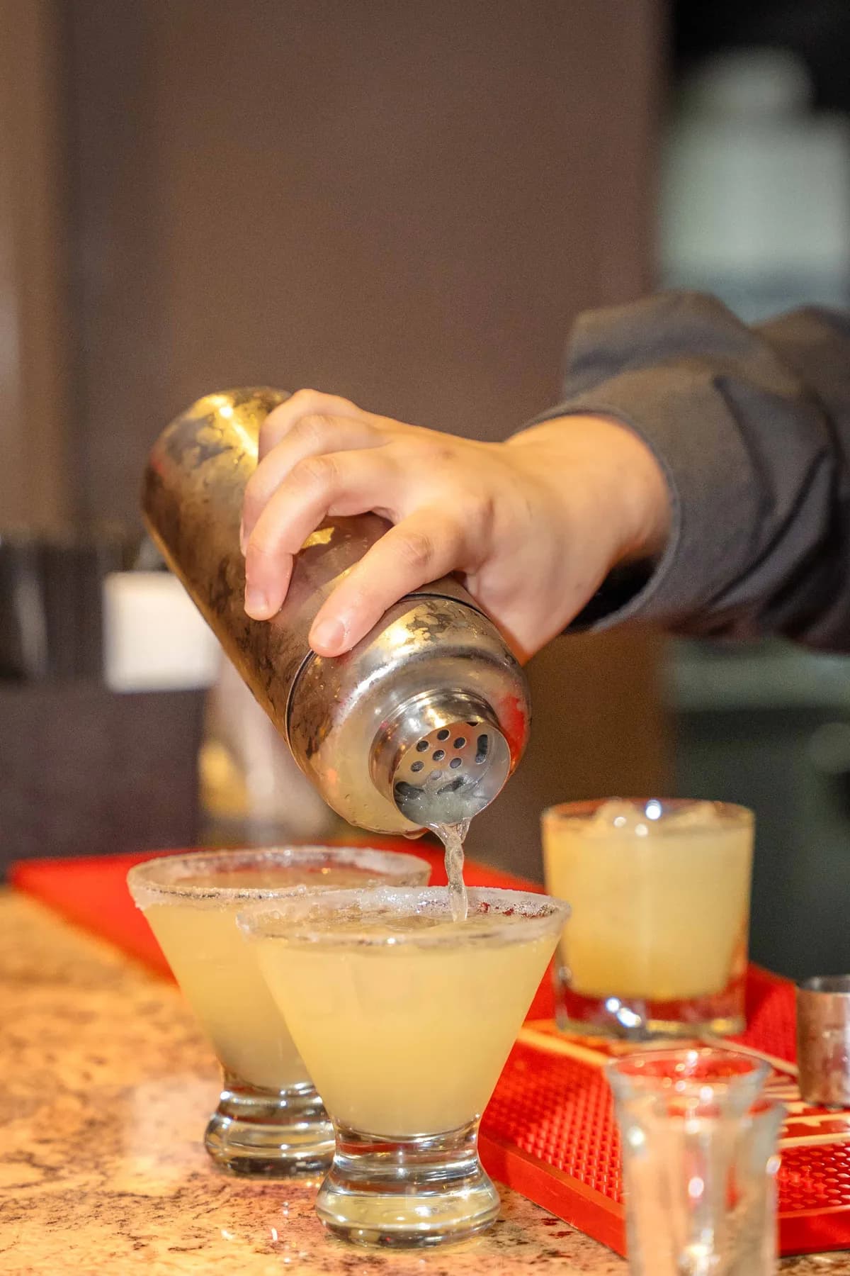 A drink being poured at the bar at Jessie and Erin’s Haldi celebration.