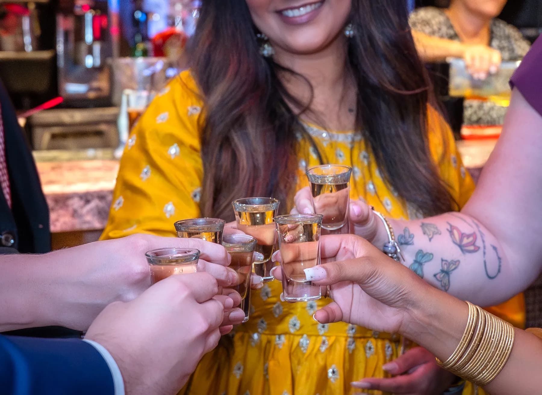 Guests raising their glasses at Jessie and Erin’s Haldi celebration.