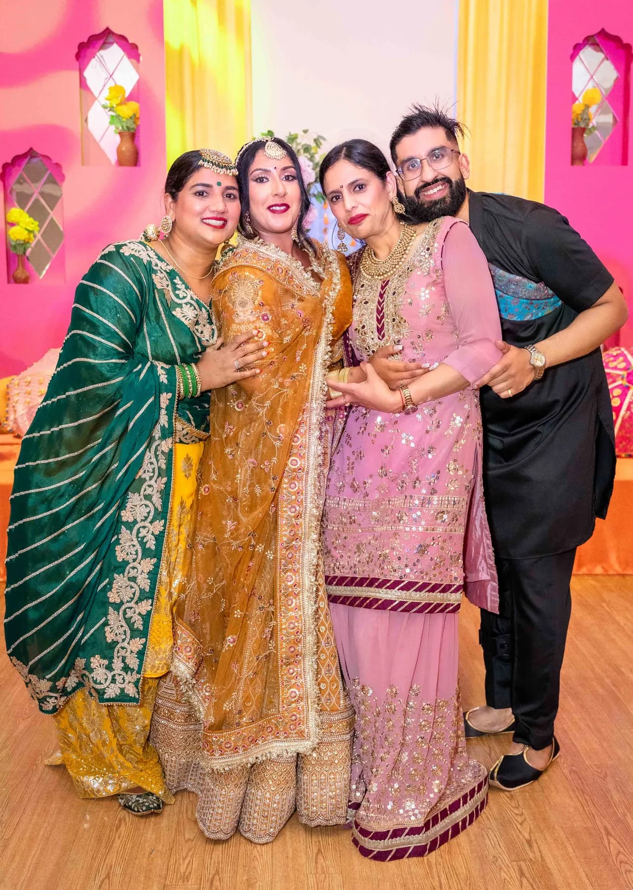 Guests posing together at Jessie and Erin’s Haldi celebration.